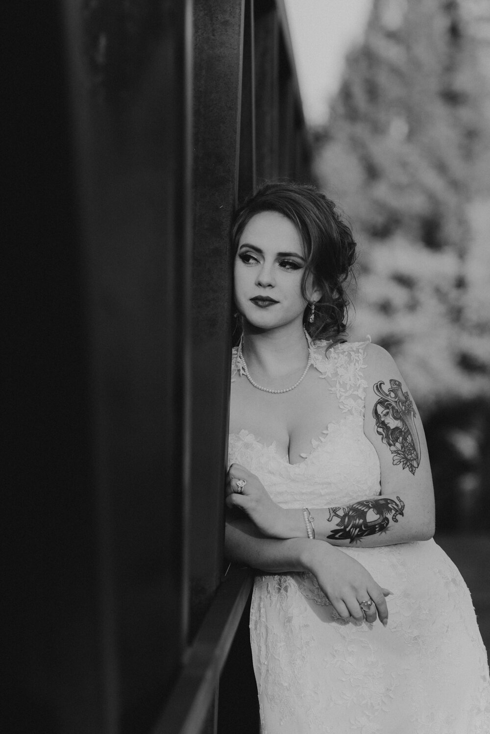 River School Farm Wedding, photo of bride leaning on bridge b&amp;w