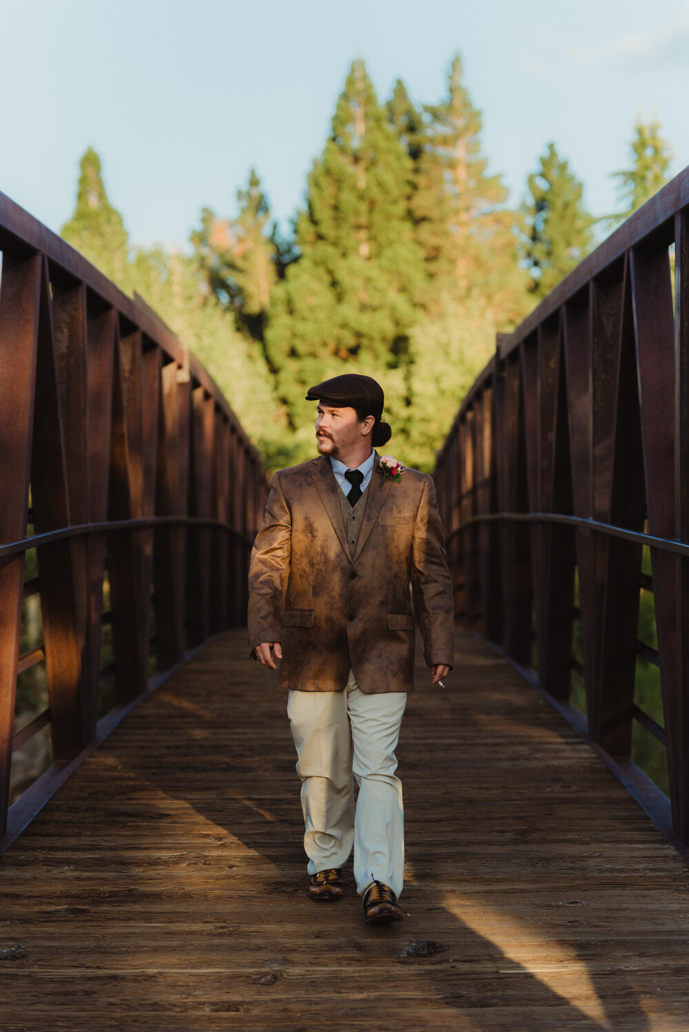 River School Farm Wedding, photo of groom walking on bridge 