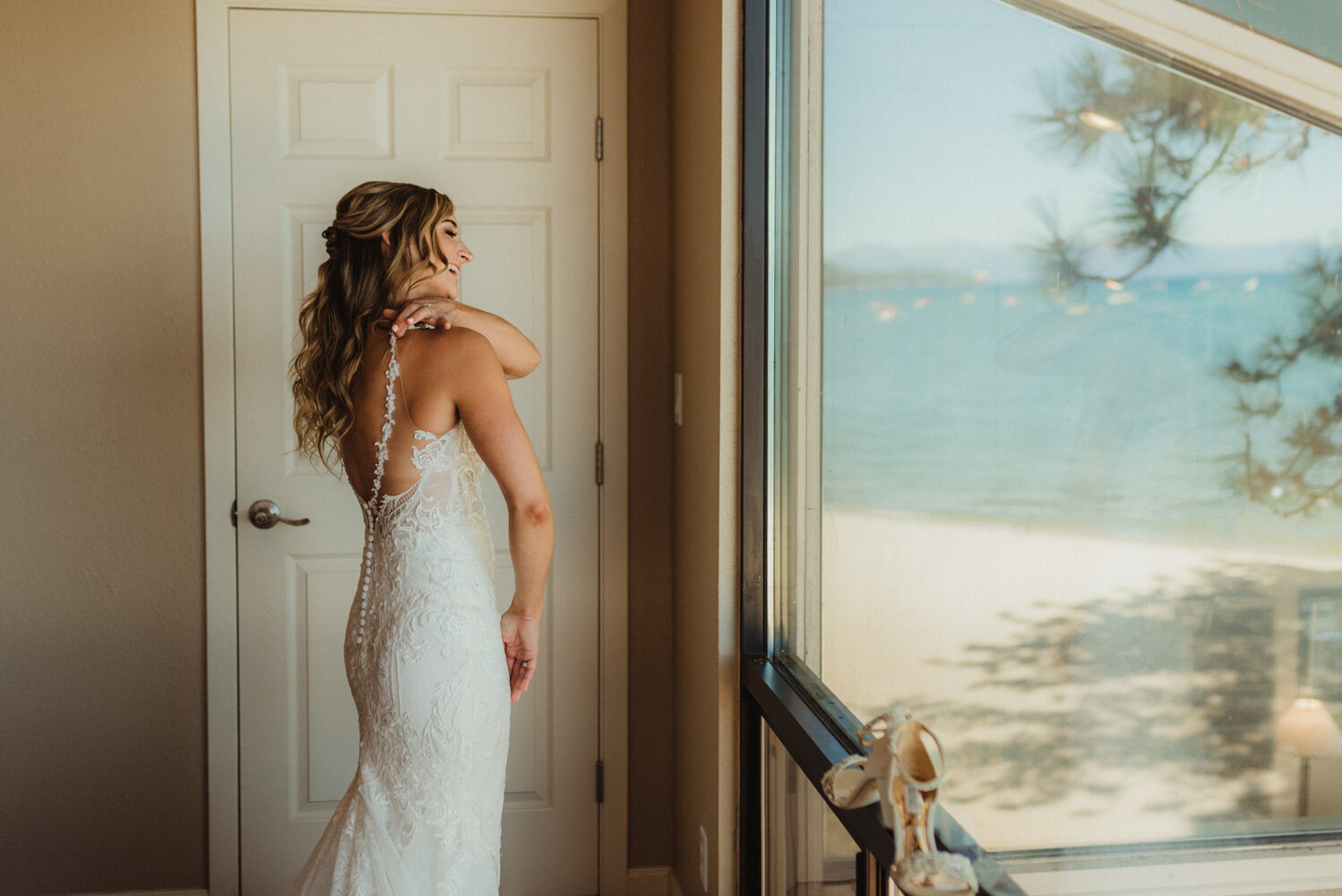 Edgewood Tahoe Wedding, photo of bride putting on her wedding dress