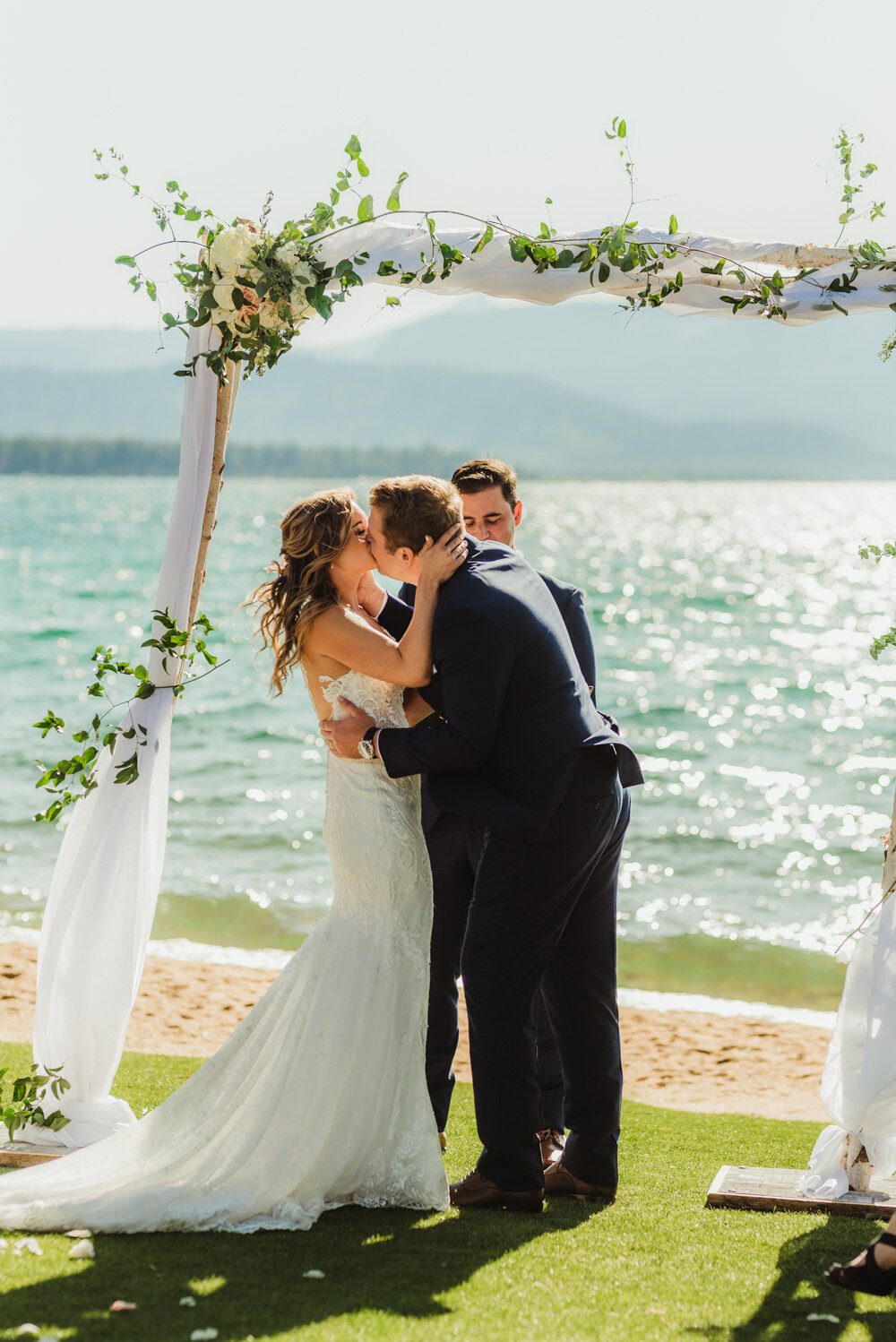 Edgewood Tahoe Wedding, photo of couple having their first kiss with Tahoe in the background 