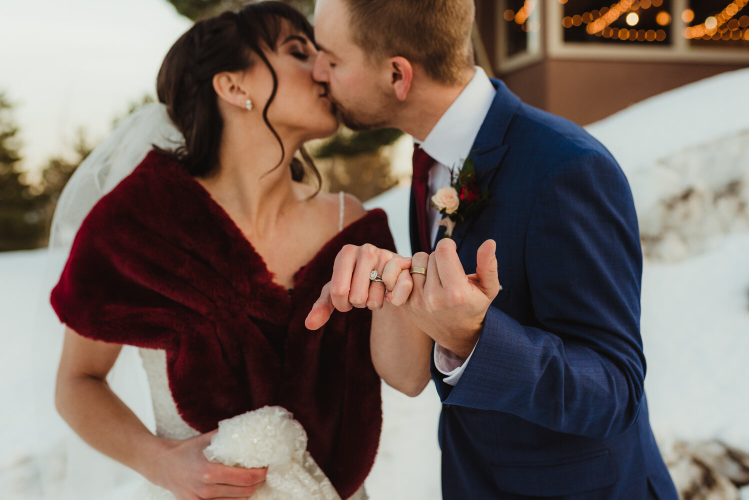 Tannenbaum Winter Wedding, photo of couple kissing while they pinky promise 