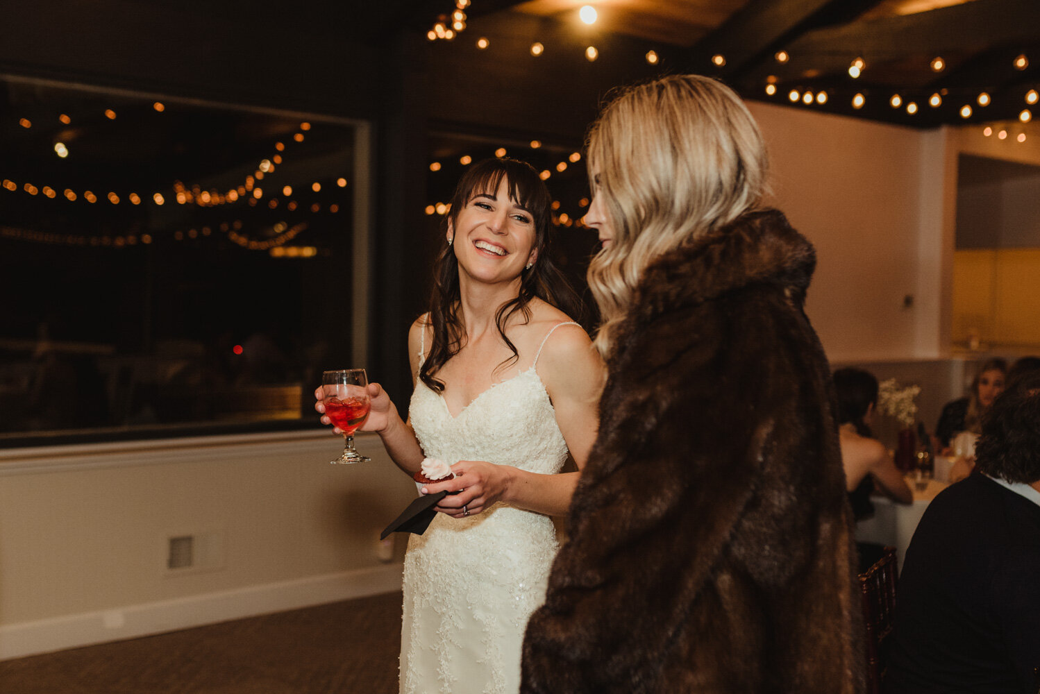 Tannenbaum Winter Wedding, photo of bride chatting with a friend 