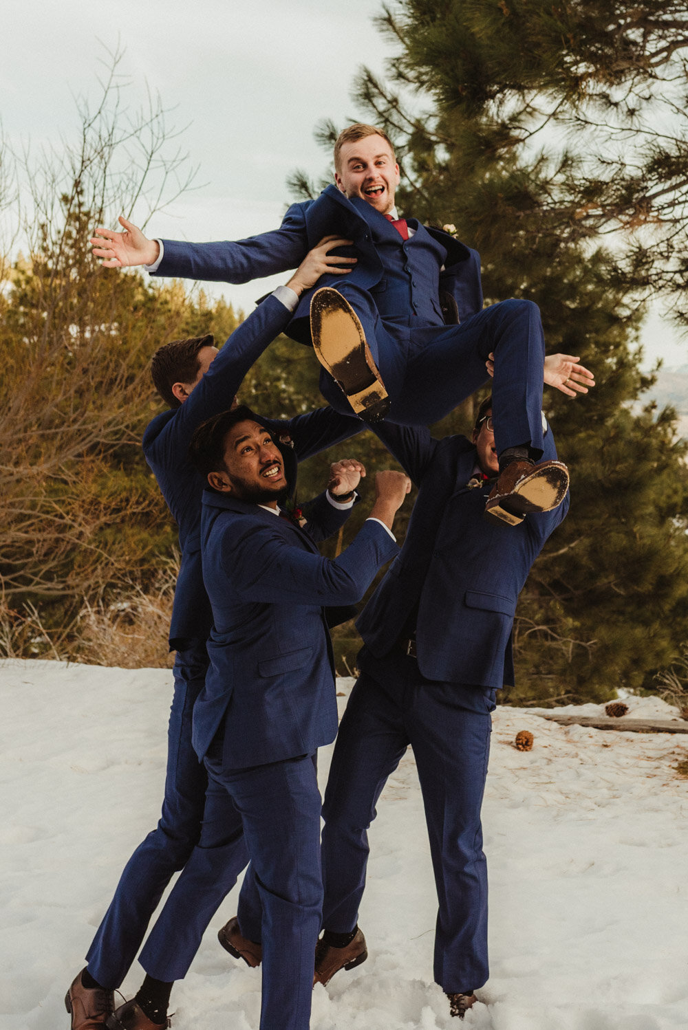 Tannenbaum Winter Wedding, photo of groom being thrown in the air 