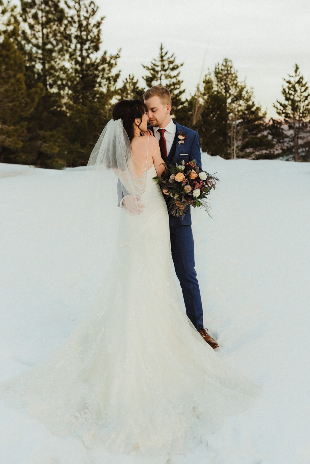 Tannenbaum Winter Wedding, photo of couple kissing in the snow