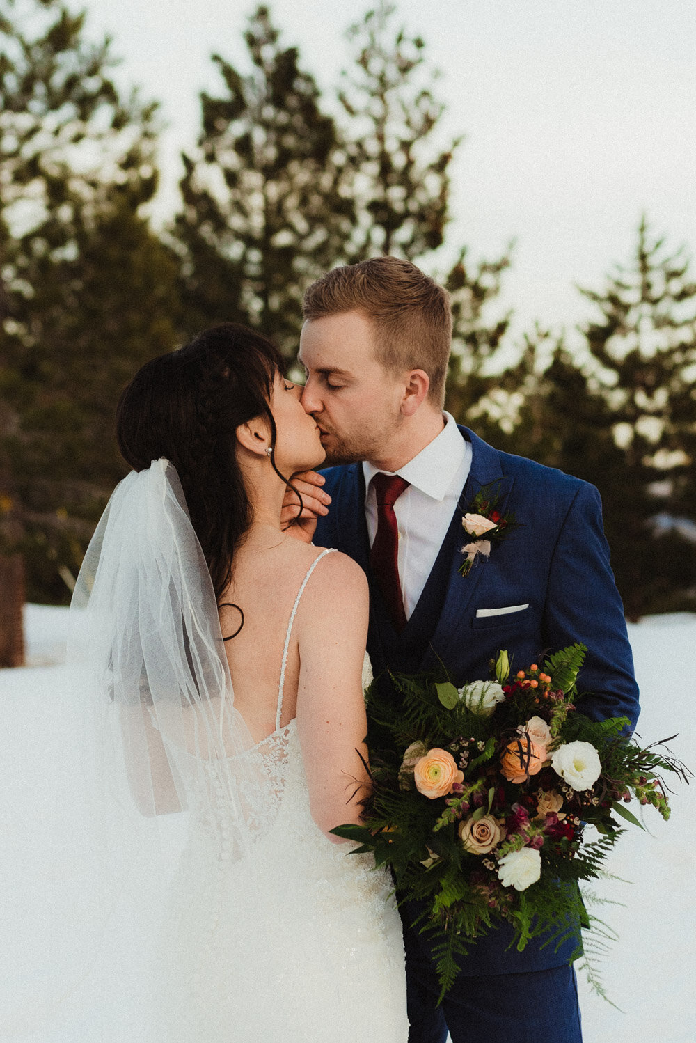Tannenbaum Winter Wedding, photo of couple kissing in the snow