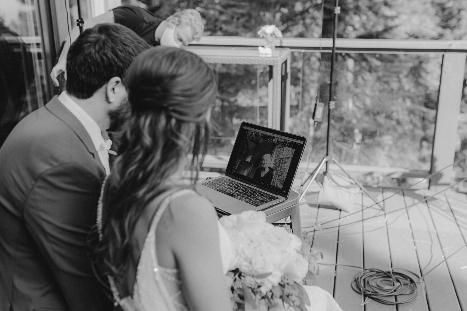 COVID Wedding, streamed through zoom, photo of couple talking to grandma virtually