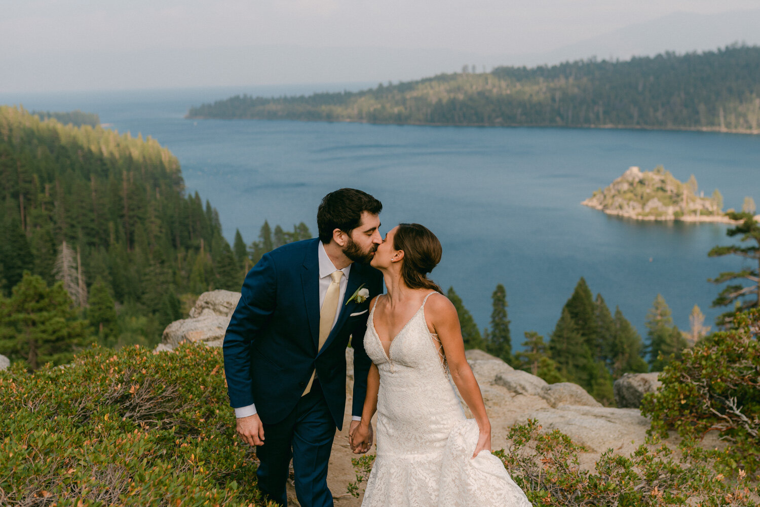 COVID Wedding in Lake Tahoe, couple kissing with emerald bay in the background