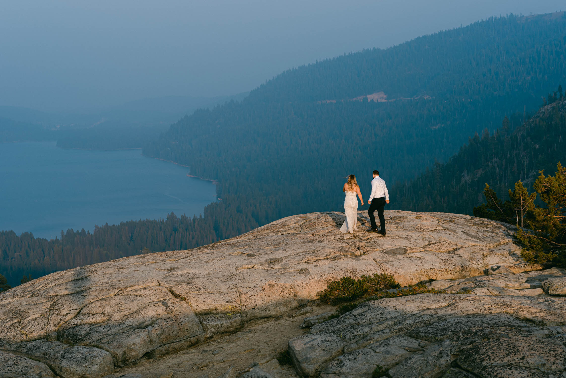 Donner Lake Elopement, photo of couple walking on a granite rock overlooking Donner Lake