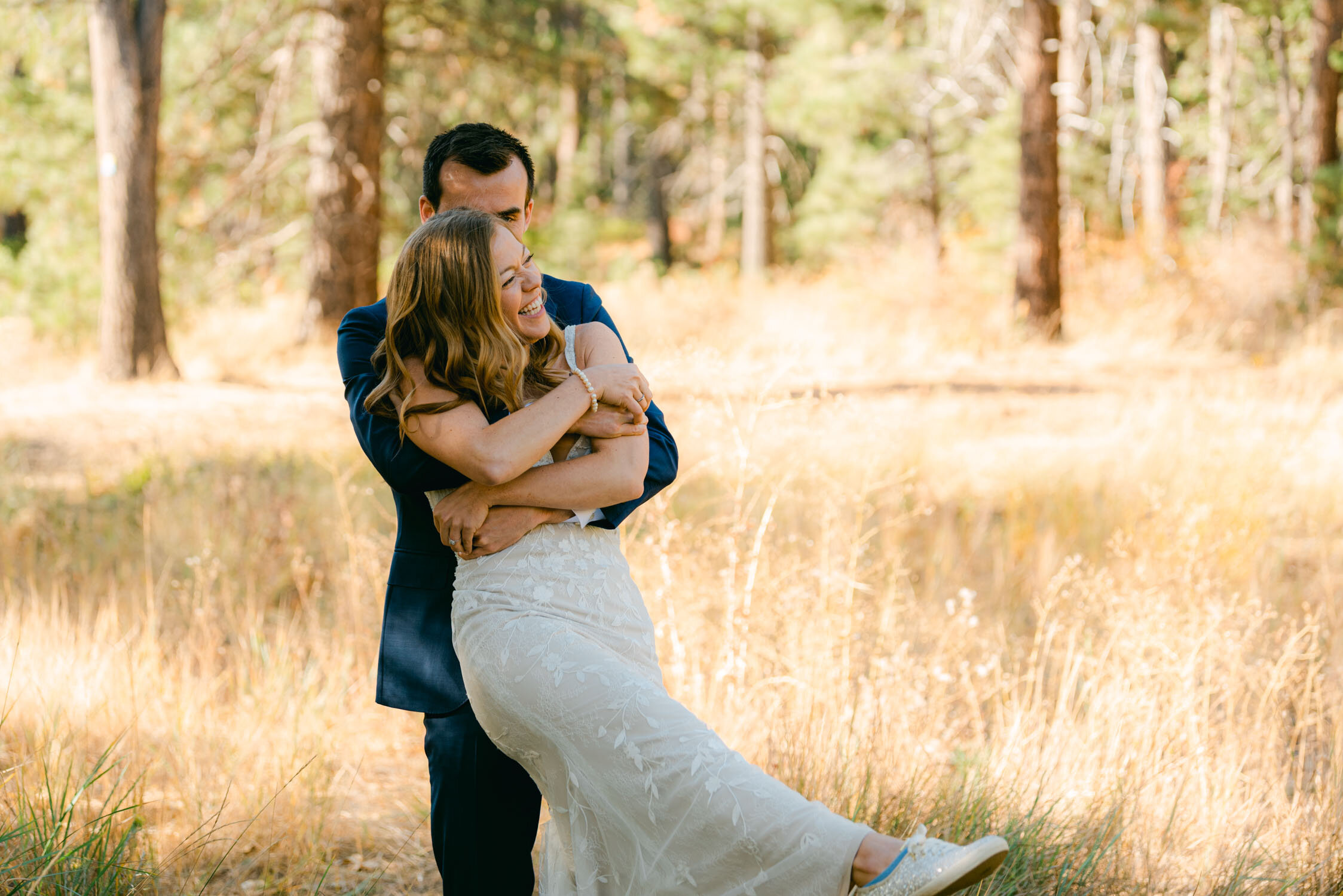 Fall Lake Tahoe wedding, photo of groom hugging his bride photo