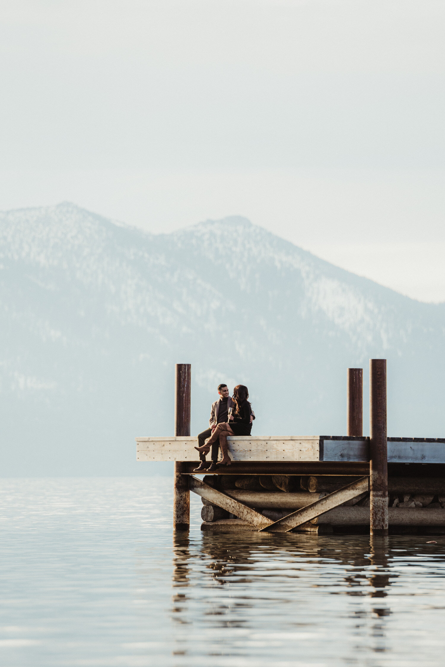 Lake Tahoe Proposal, photo of couple sitting on the dock