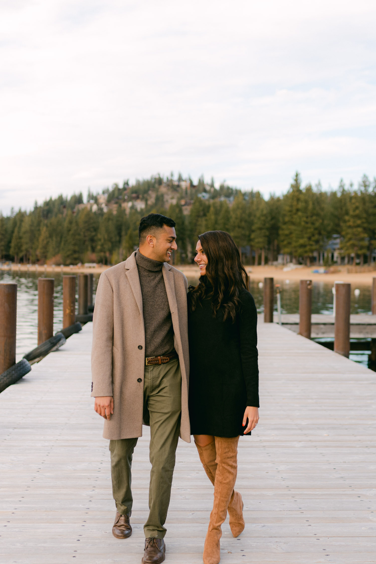 Lake Tahoe Proposal, photo of couple smiling at each other while walking on a dock