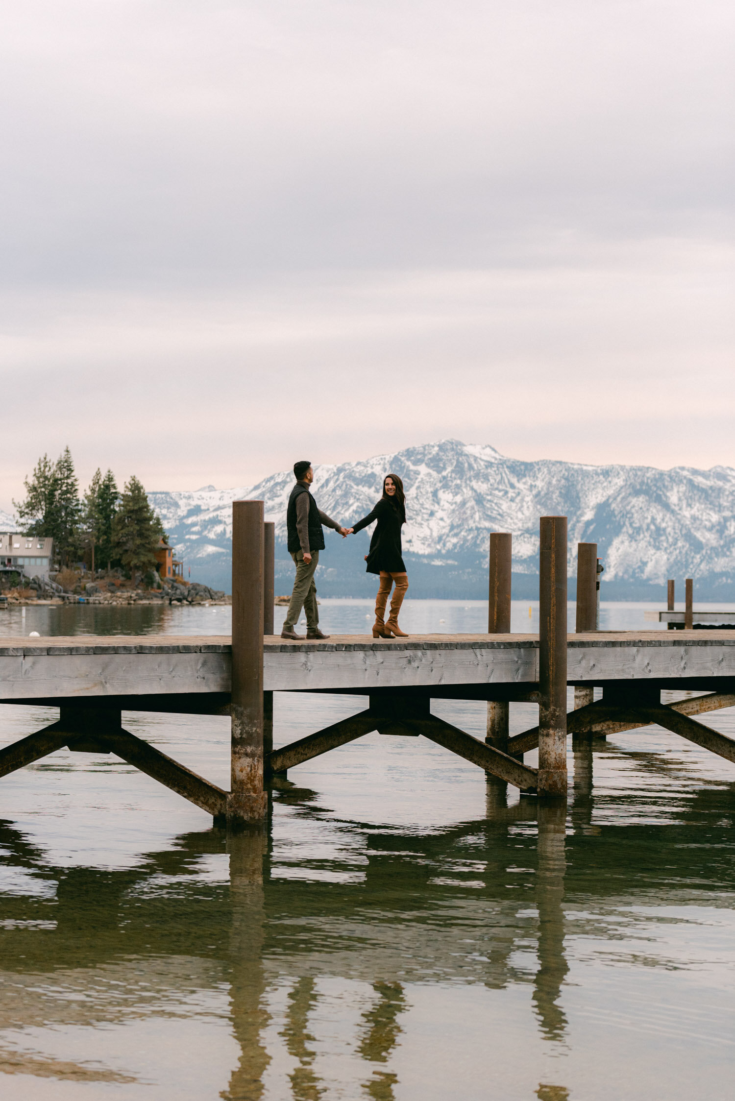 Lake Tahoe Proposal, with a surprise photographer, couple walking on a dock