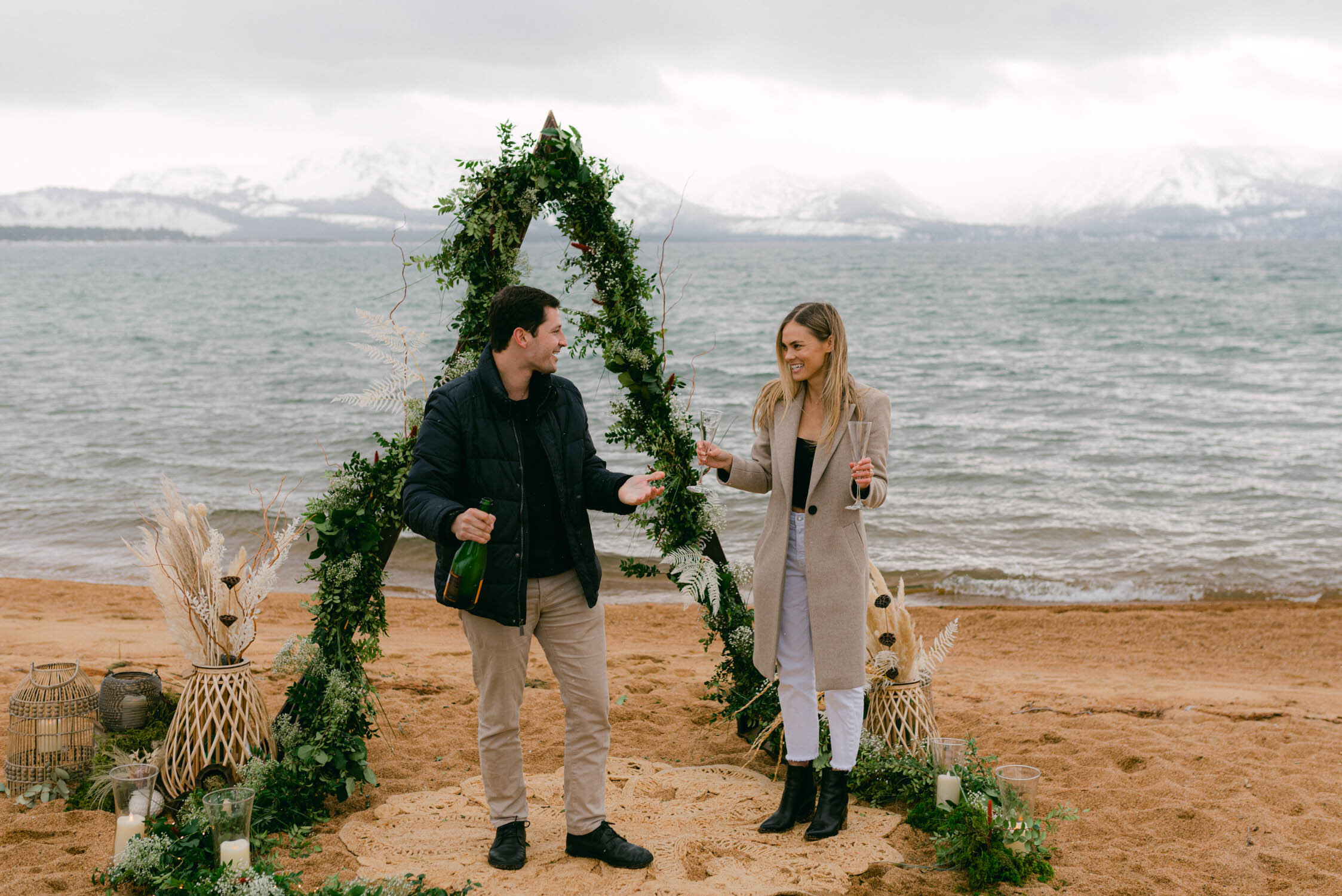 Lake Tahoe Proposal at Edgewood, photo of a couple about to celebreate their engagment with a bottle of champagne