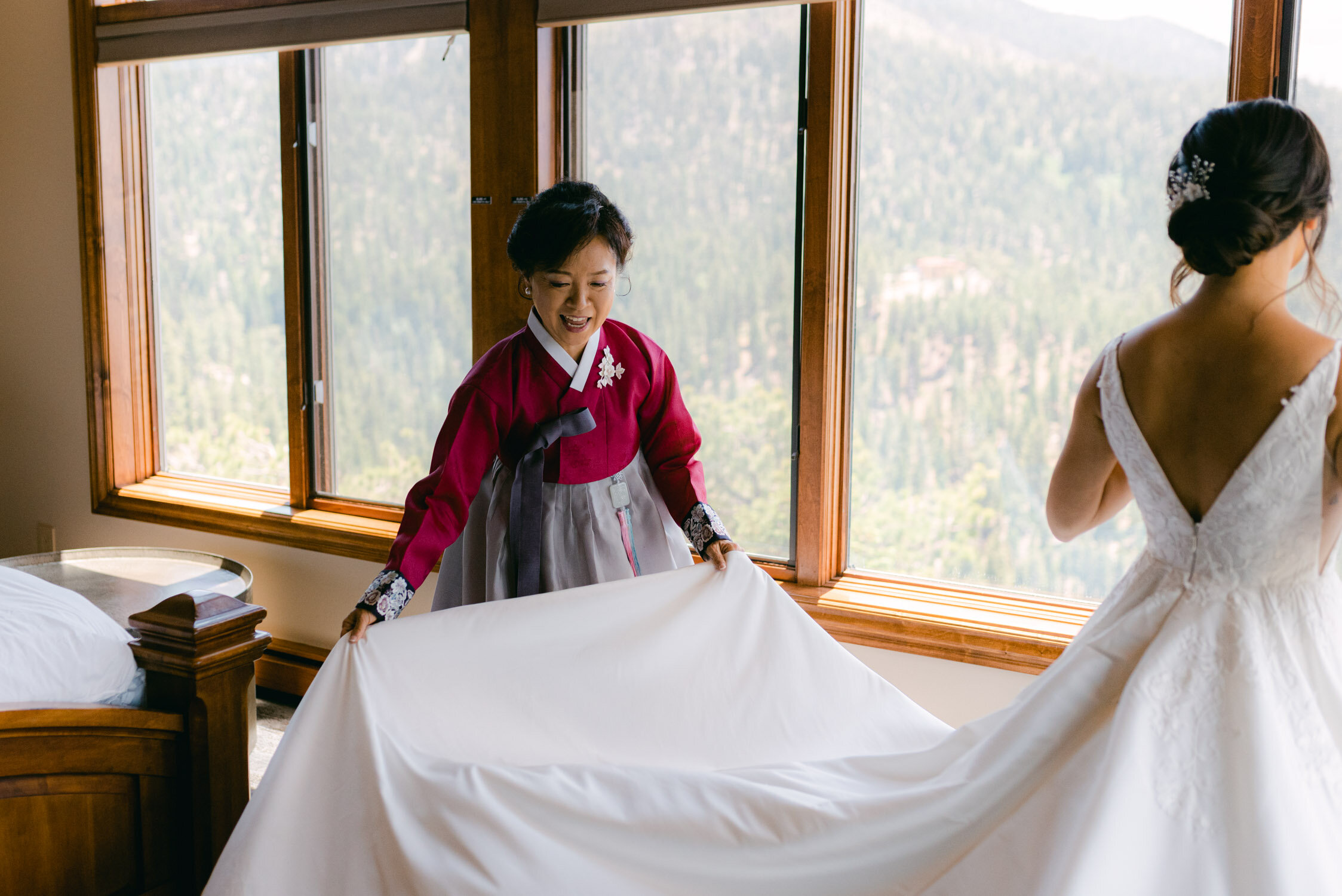 Tahoe Blue Estate Wedding photo of bride helping her daughter with the wedding dress
