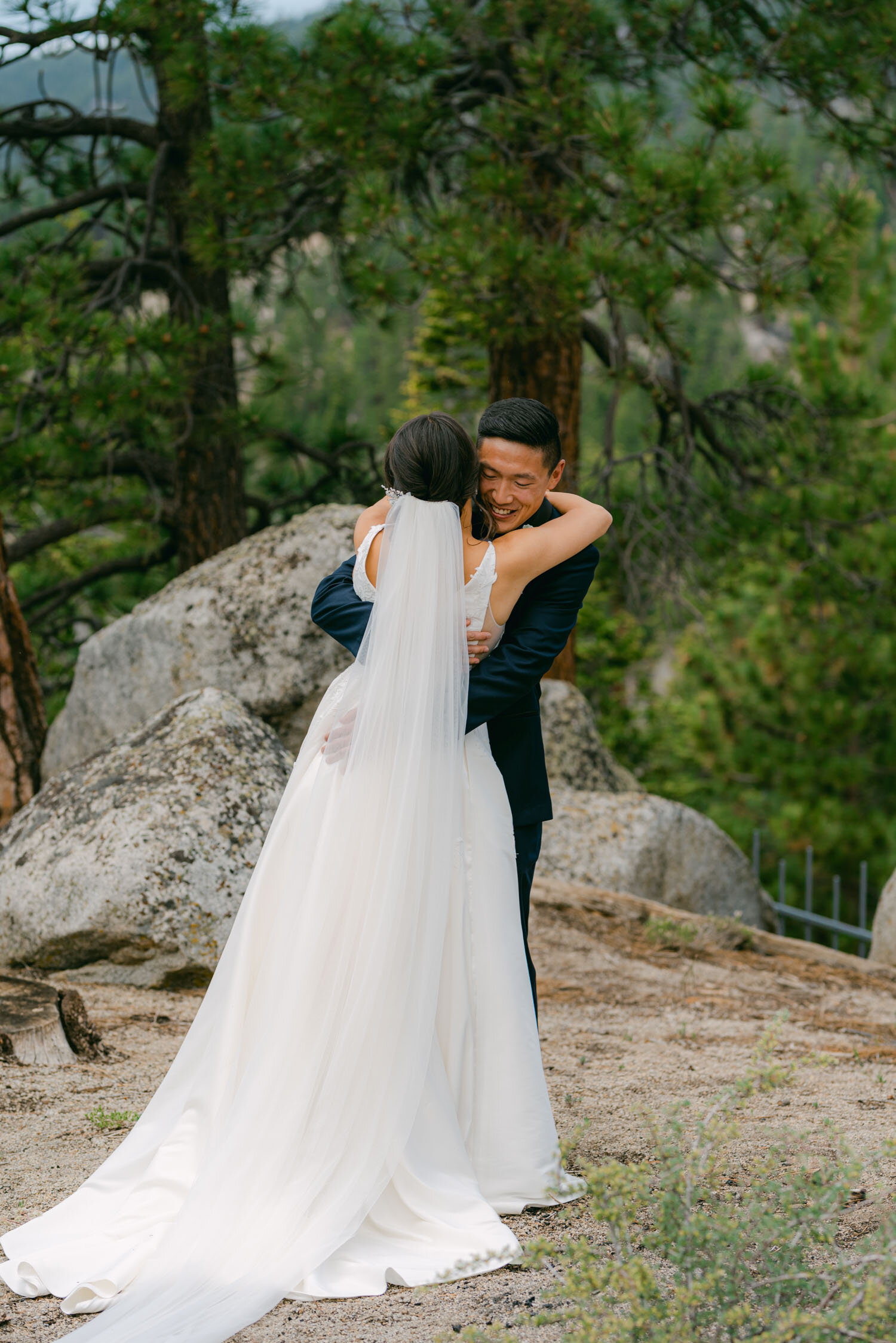 Tahoe Blue Estate Wedding photo of couple hugging after their first look in the Lake Tahoe forest