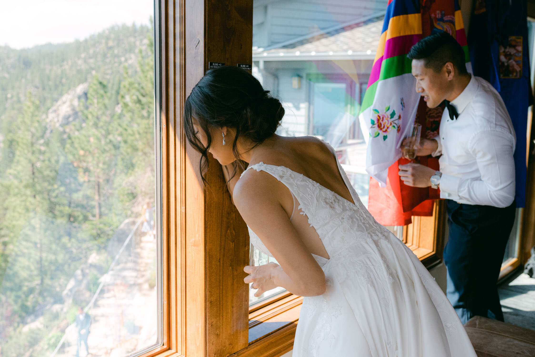 Tahoe Blue Estate Wedding, photo of couple peaking at their wedding guests from the master suite. 