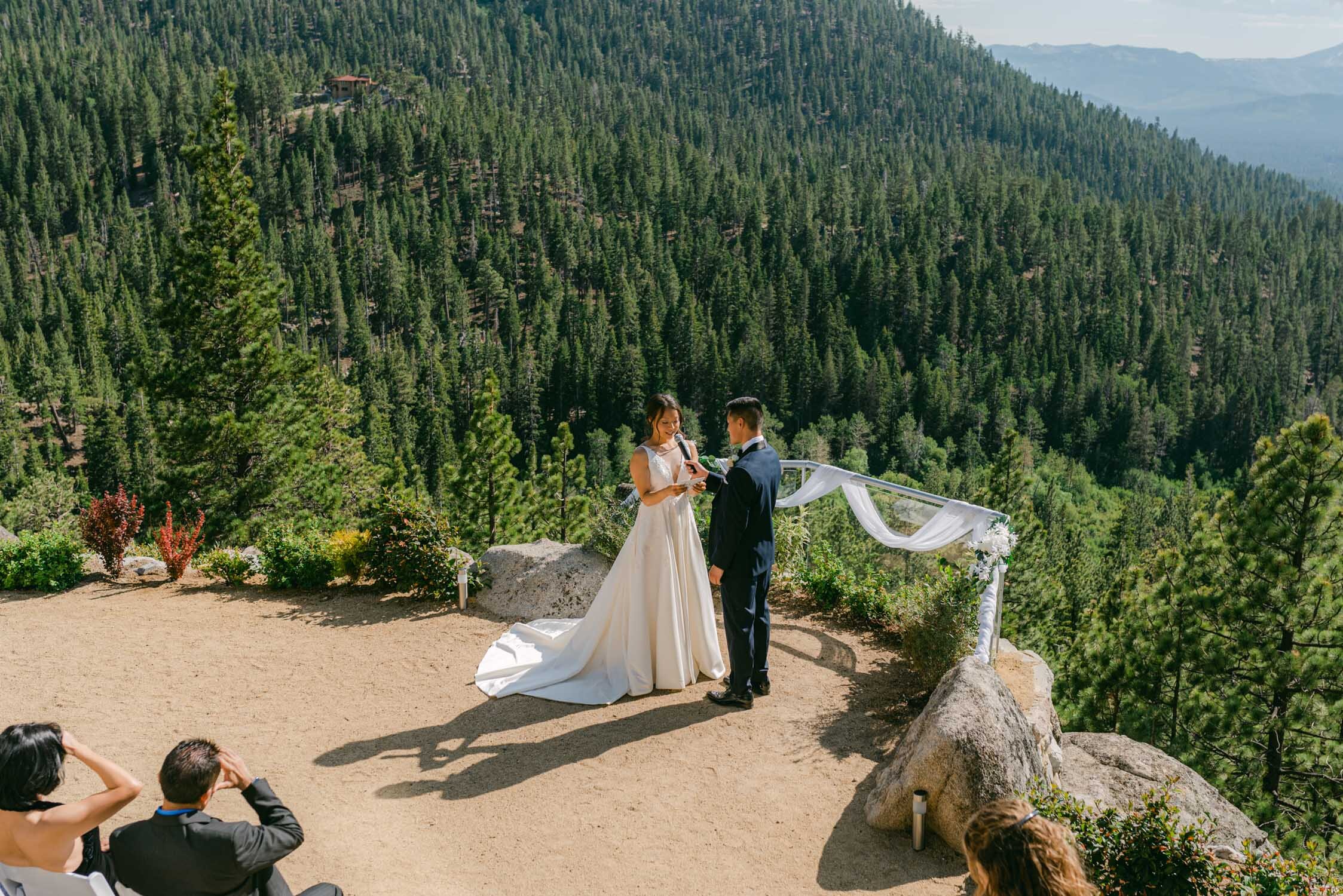 Tahoe Blue Estate Wedding, photo of couple reading their vows overlooking Tahoe