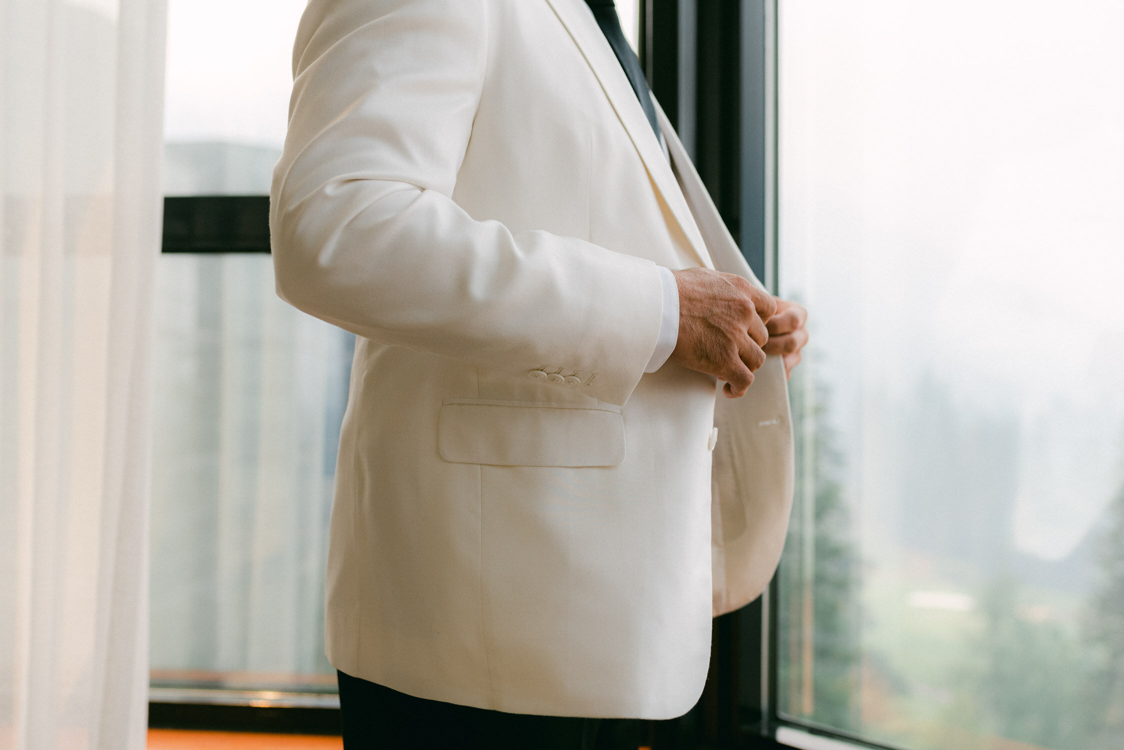Palisades Wedding, photo of groom wearing a white suit