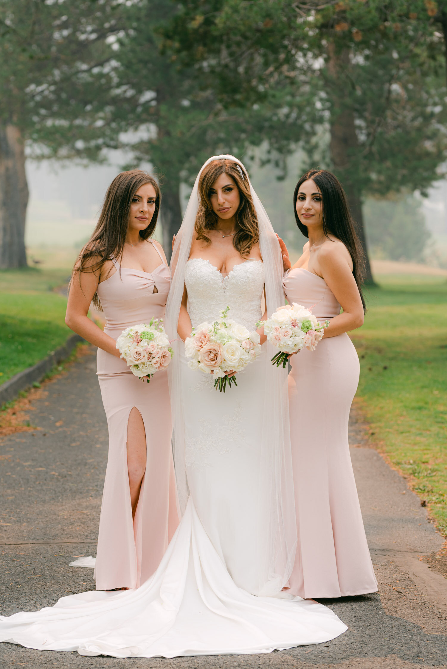 Palisades Wedding, photo of bride with her bridesmaids. Bridesmaids are wearing pink strapless dresses. 