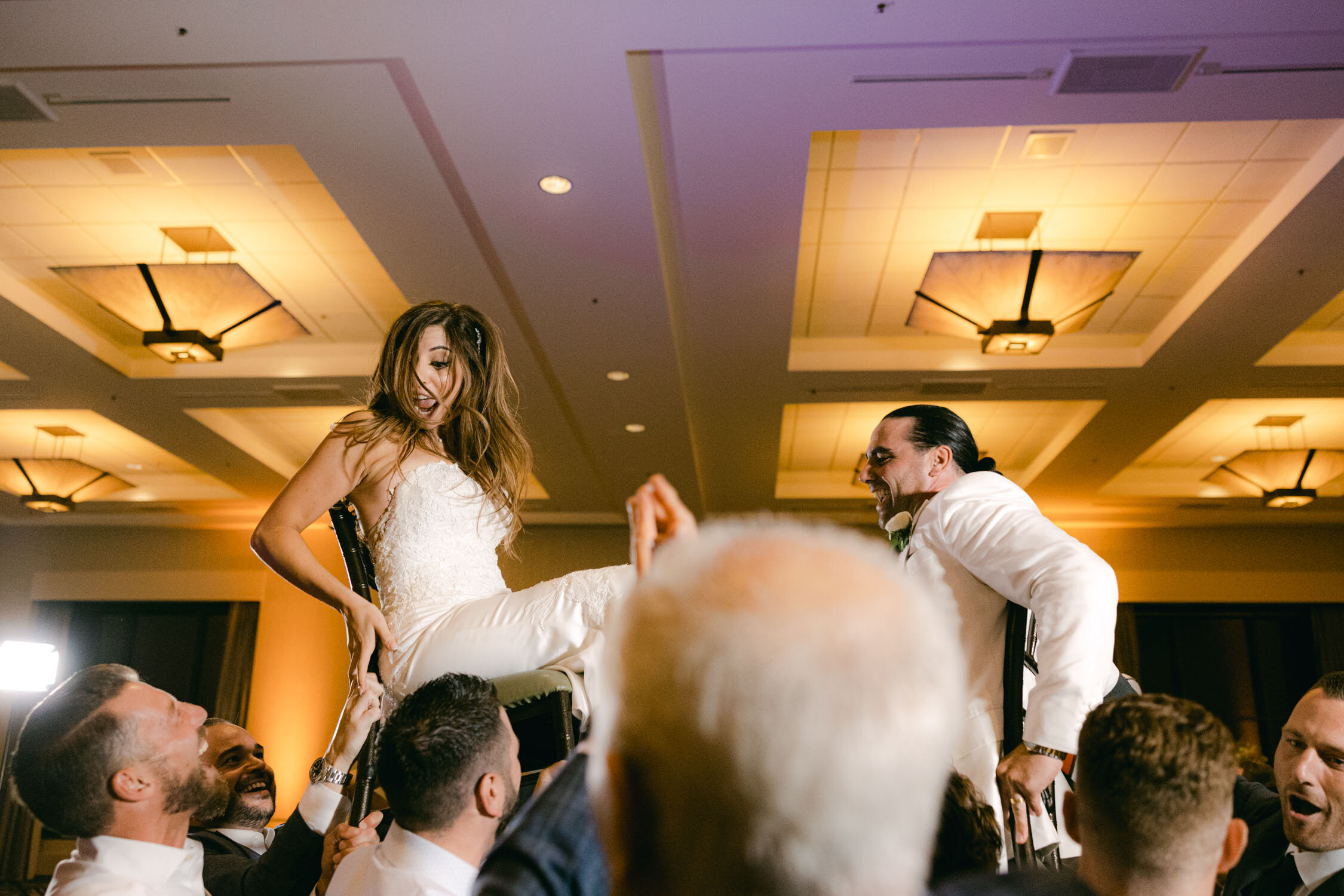 Palisades wedding, photo of couple being lifted on chairs during the arab drummer performance 