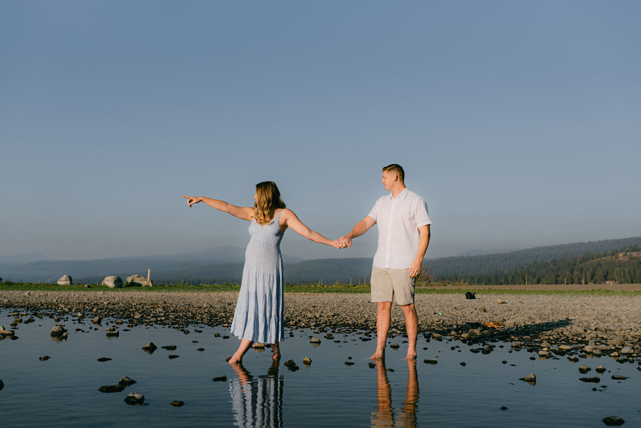Lake Tahoe Maternity Session, photo of mom-to-be pointing at the horizon 