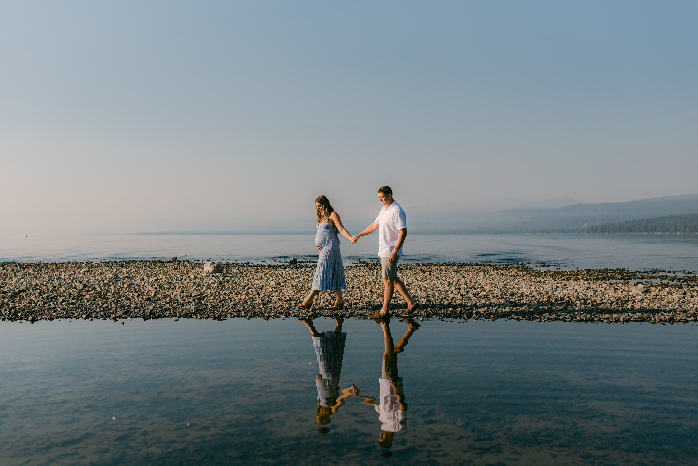 Lake Tahoe Maternity Session, wide angle shot of couple walking on a peninsula in Tahoe