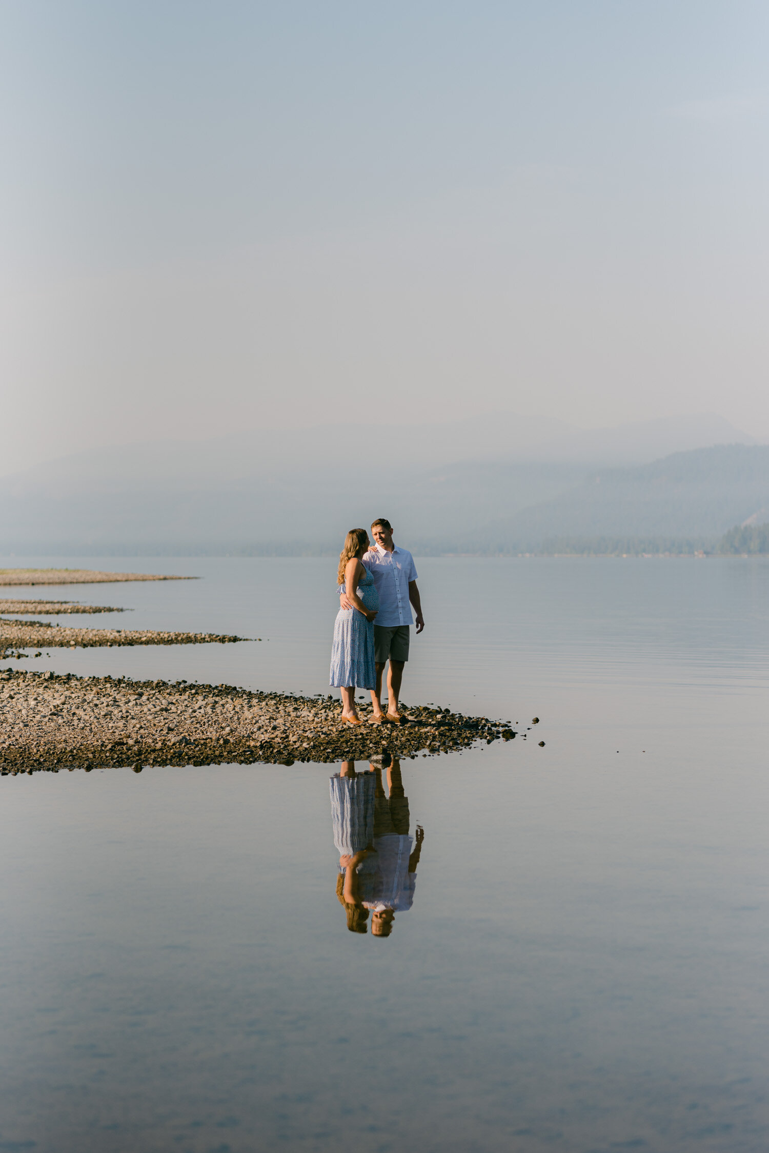 Lake Tahoe Maternity Session, photo of couple with a lake reflection