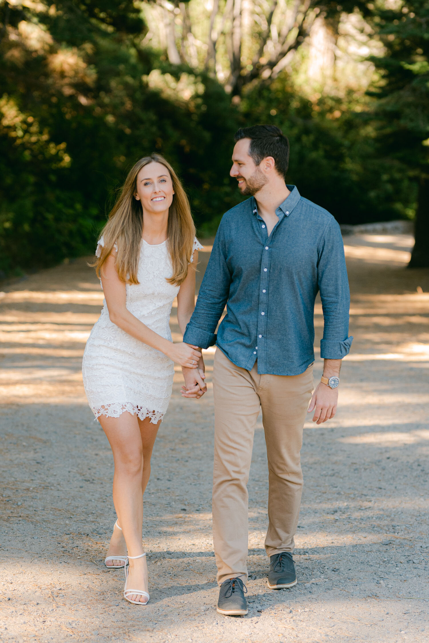 Emerald Bay engagement photoshoot, photo of a couple walking on a trail holding hands