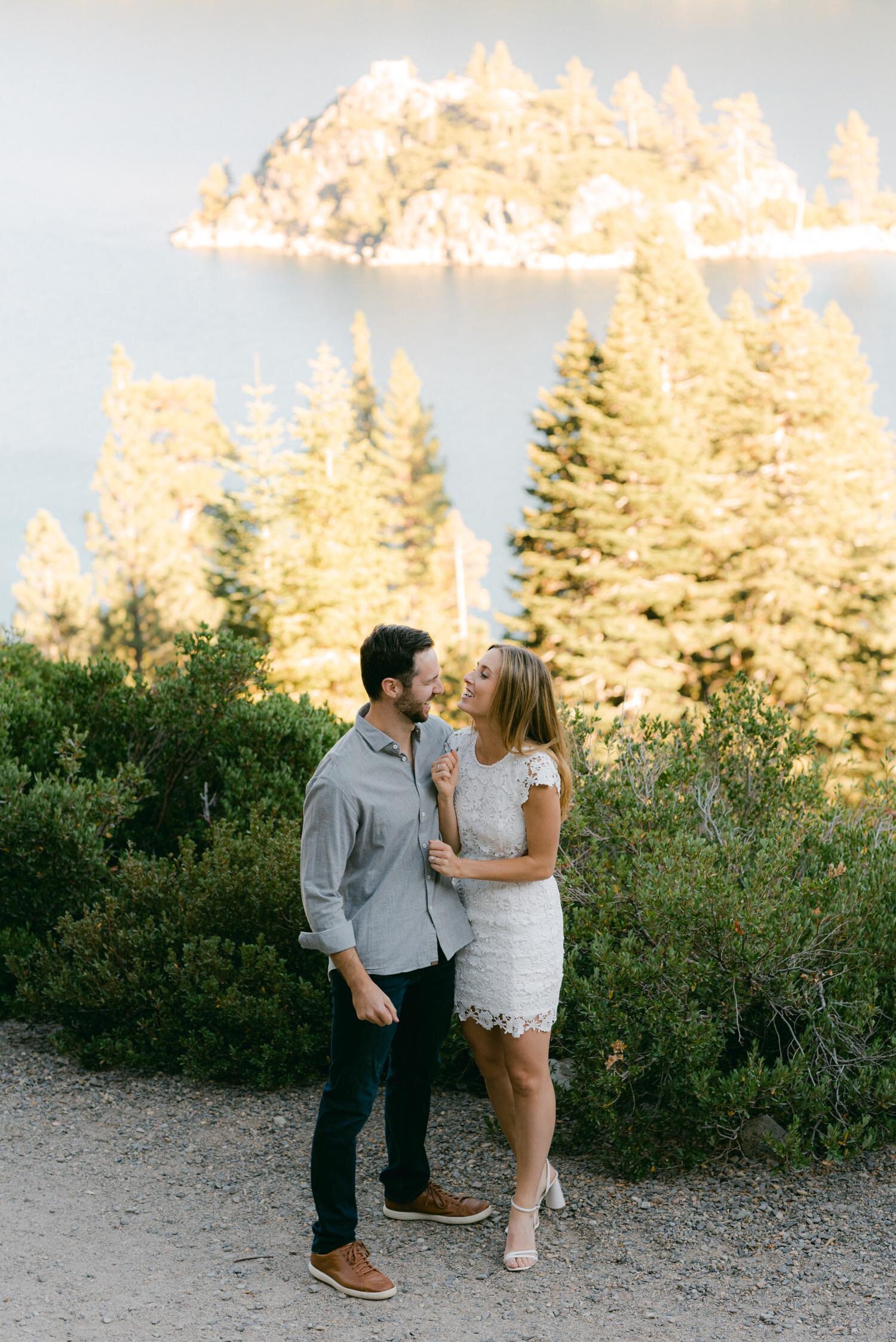 Emerald Bay engagement photoshoot, photo of a couple on a trail overlooking emerald bay