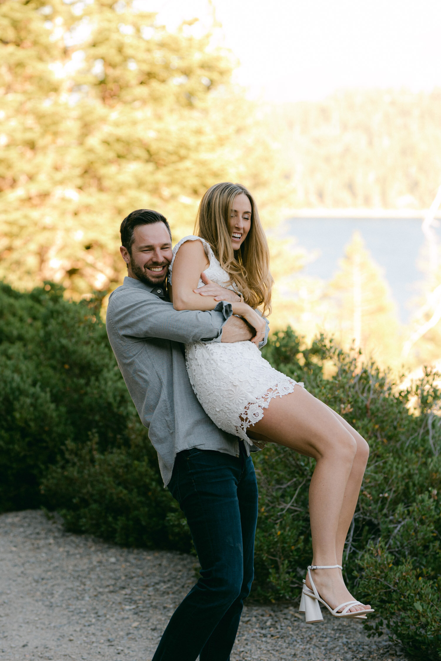 Emerald Bay engagement photoshoot, photo of a girl being bear hugged