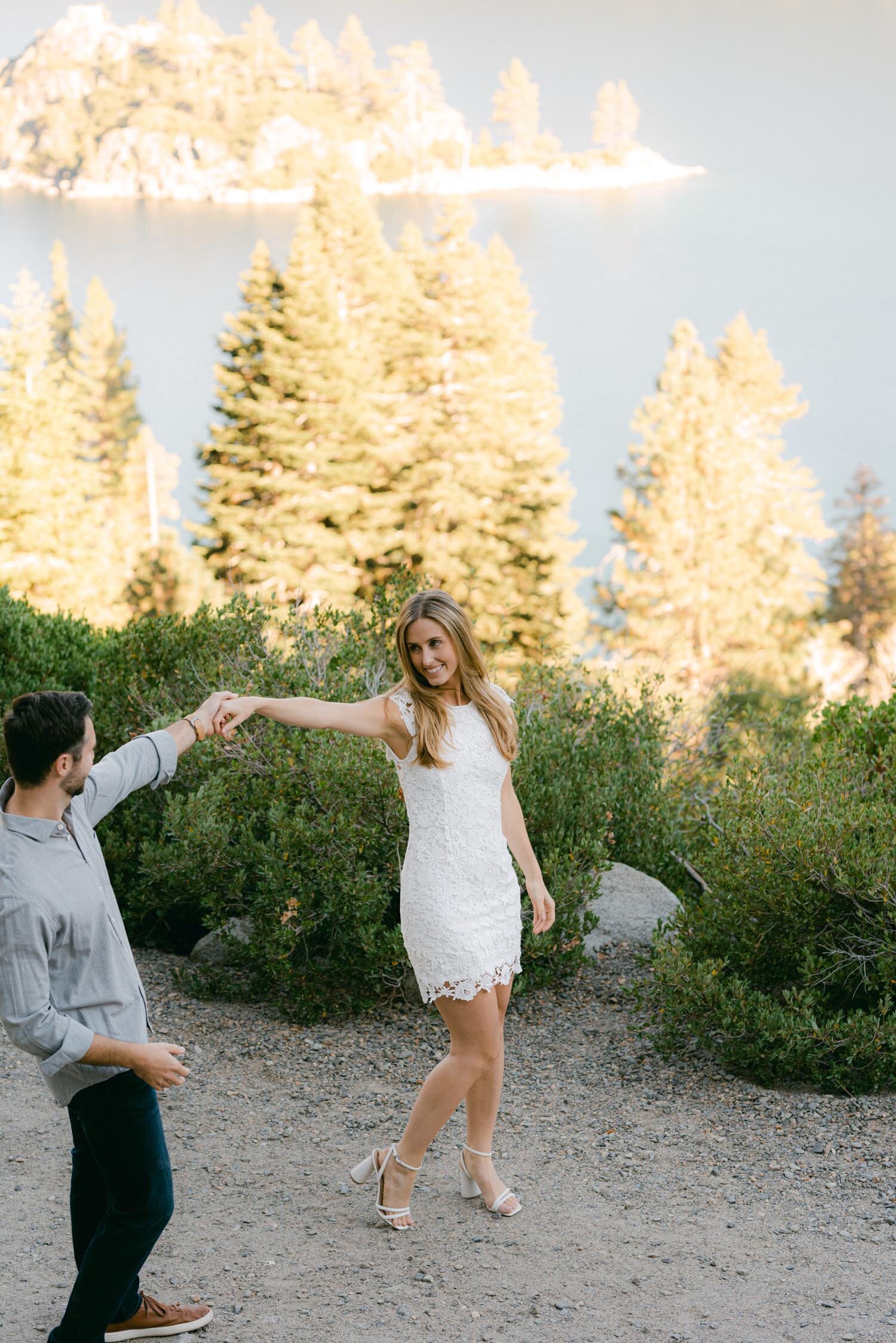 Emerald Bay engagement photoshoot, photo of a couple dancing on a trail