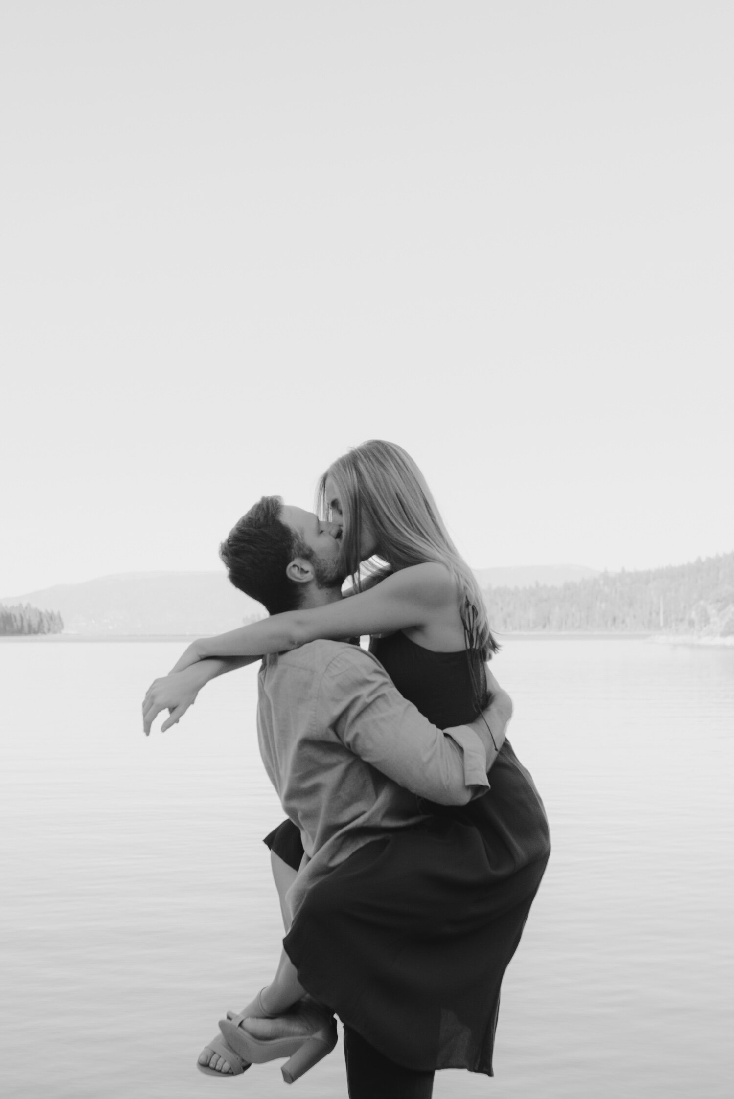 Emerald Bay engagement photoshoot, photo of a couple embracing on a dock