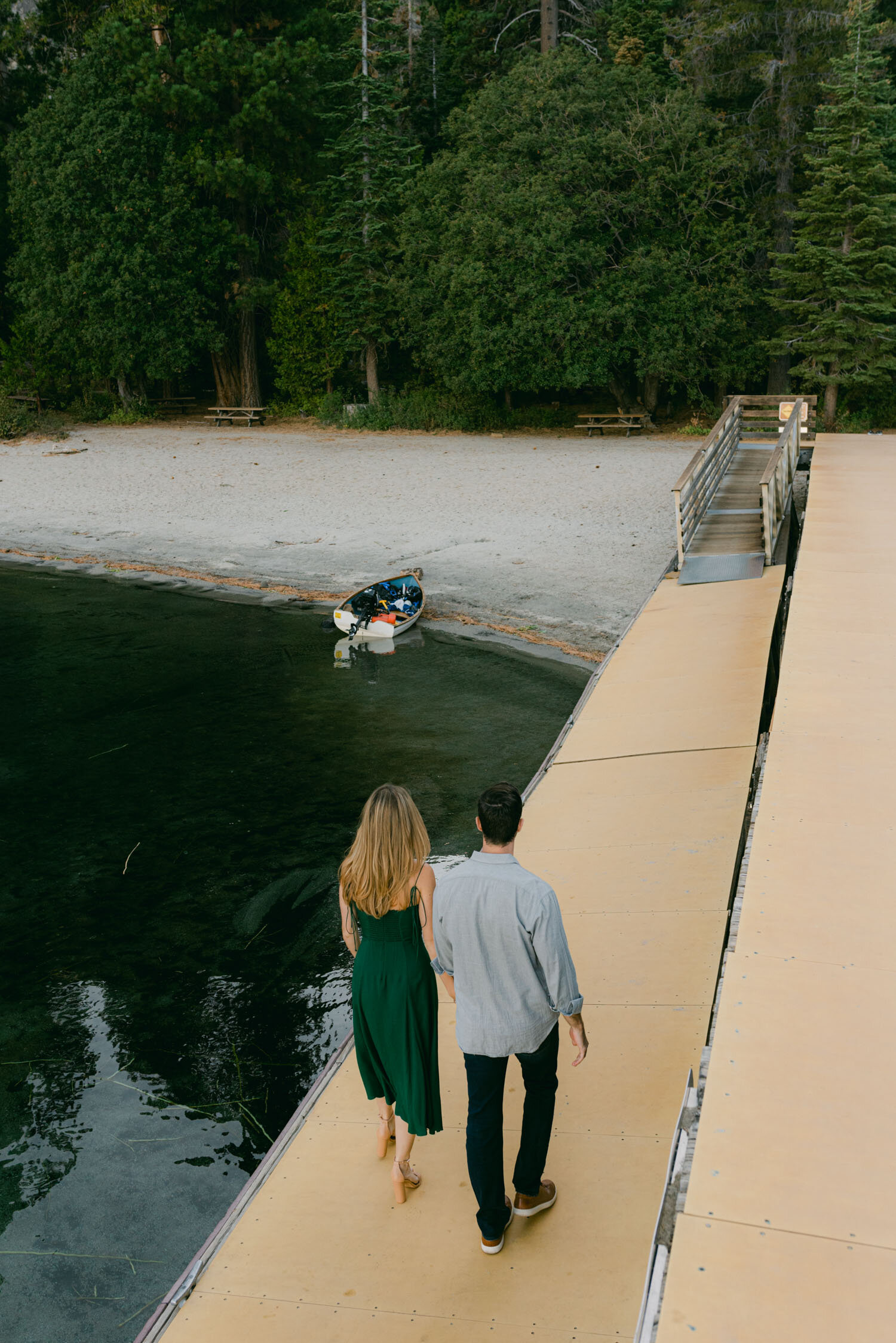 Emerald Bay engagement photoshoot, photo of a couple walking away on a dock