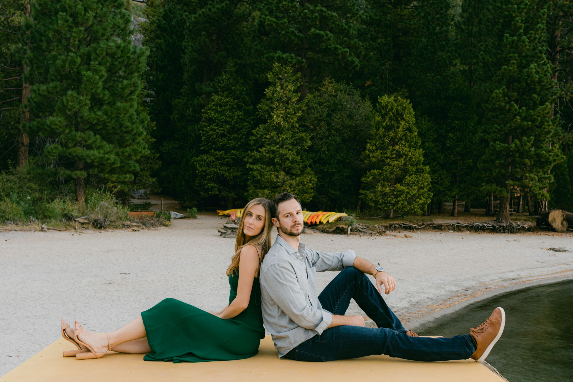 Emerald Bay engagement photoshoot, photo of a couple sitting on a dock