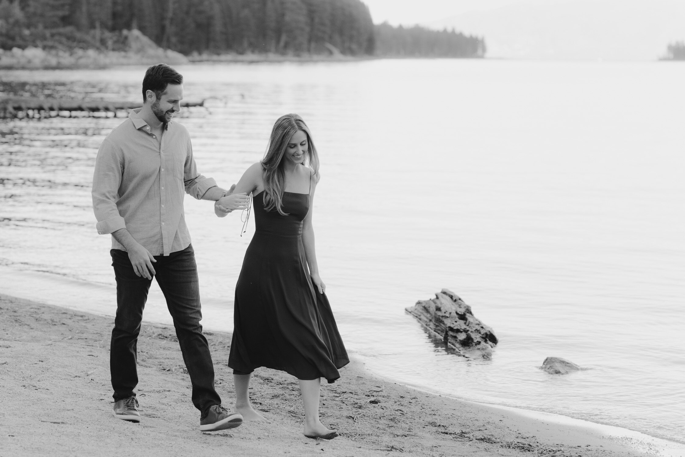 Emerald Bay engagement photoshoot, photo of a couple walking by the shores of lake tahoe