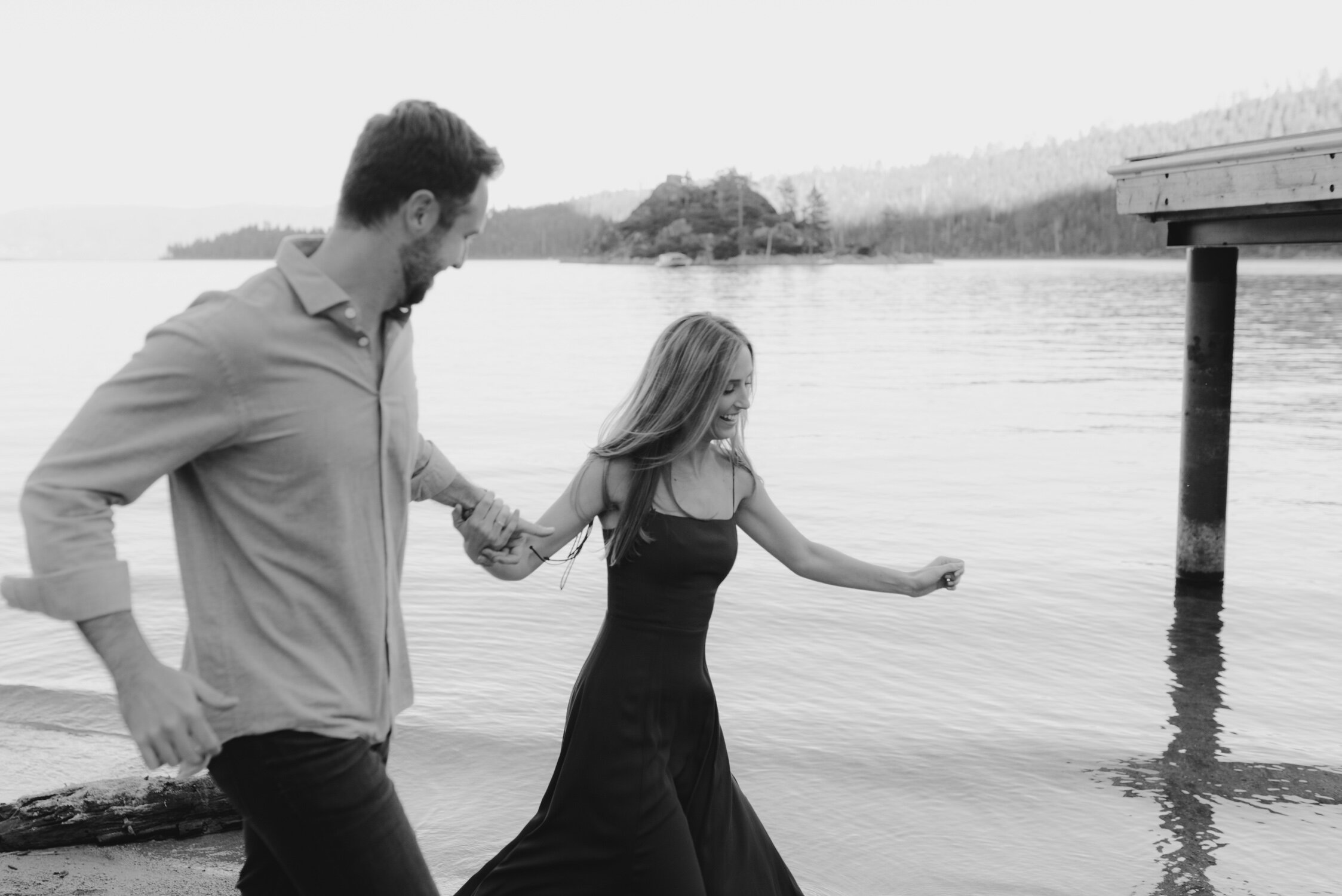 Emerald Bay engagement photoshoot, photo of a couple running by the lake