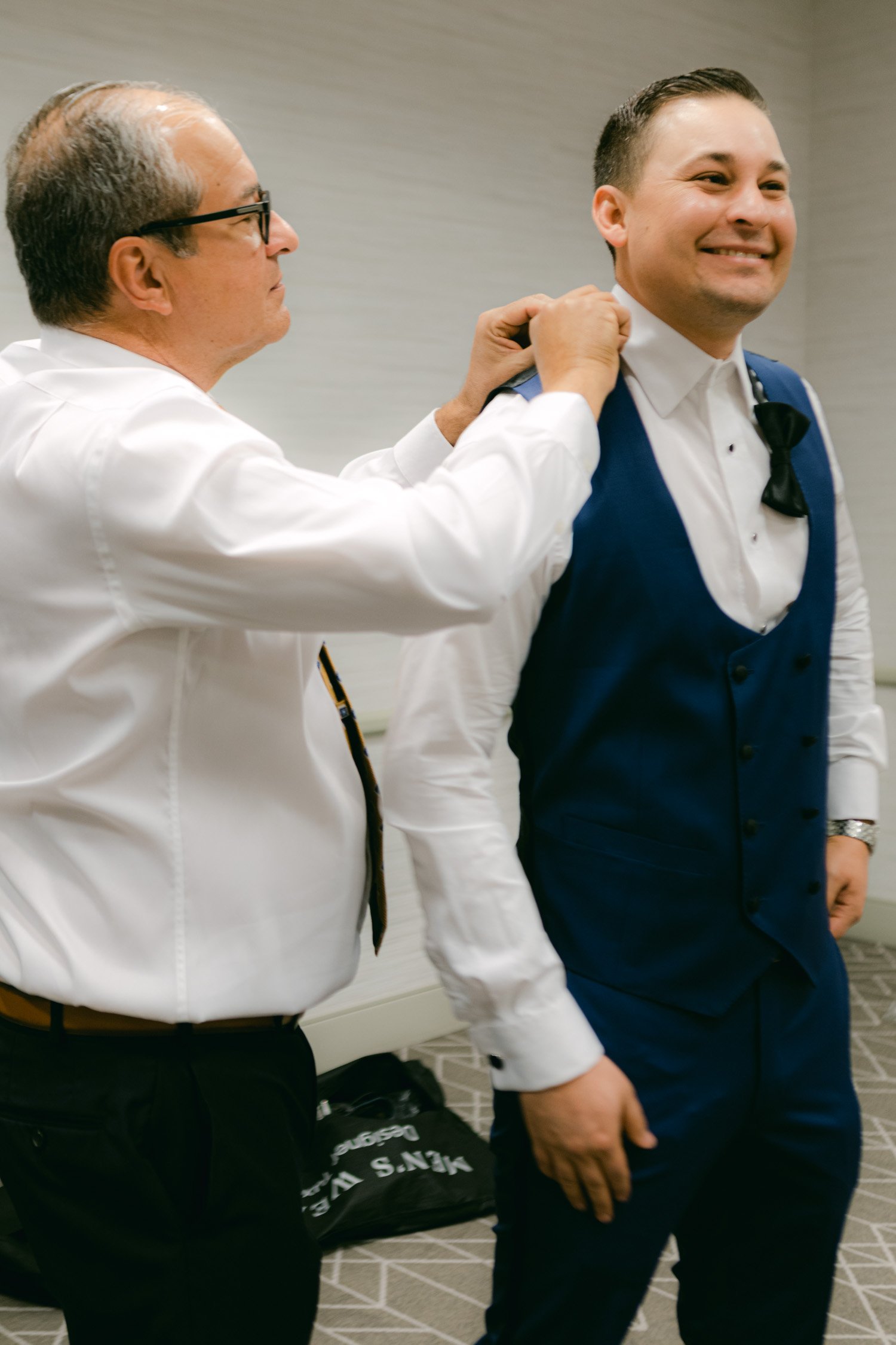 Sunnyside Tahoe Wedding, photo of dad's groom helping him with his bowtie 