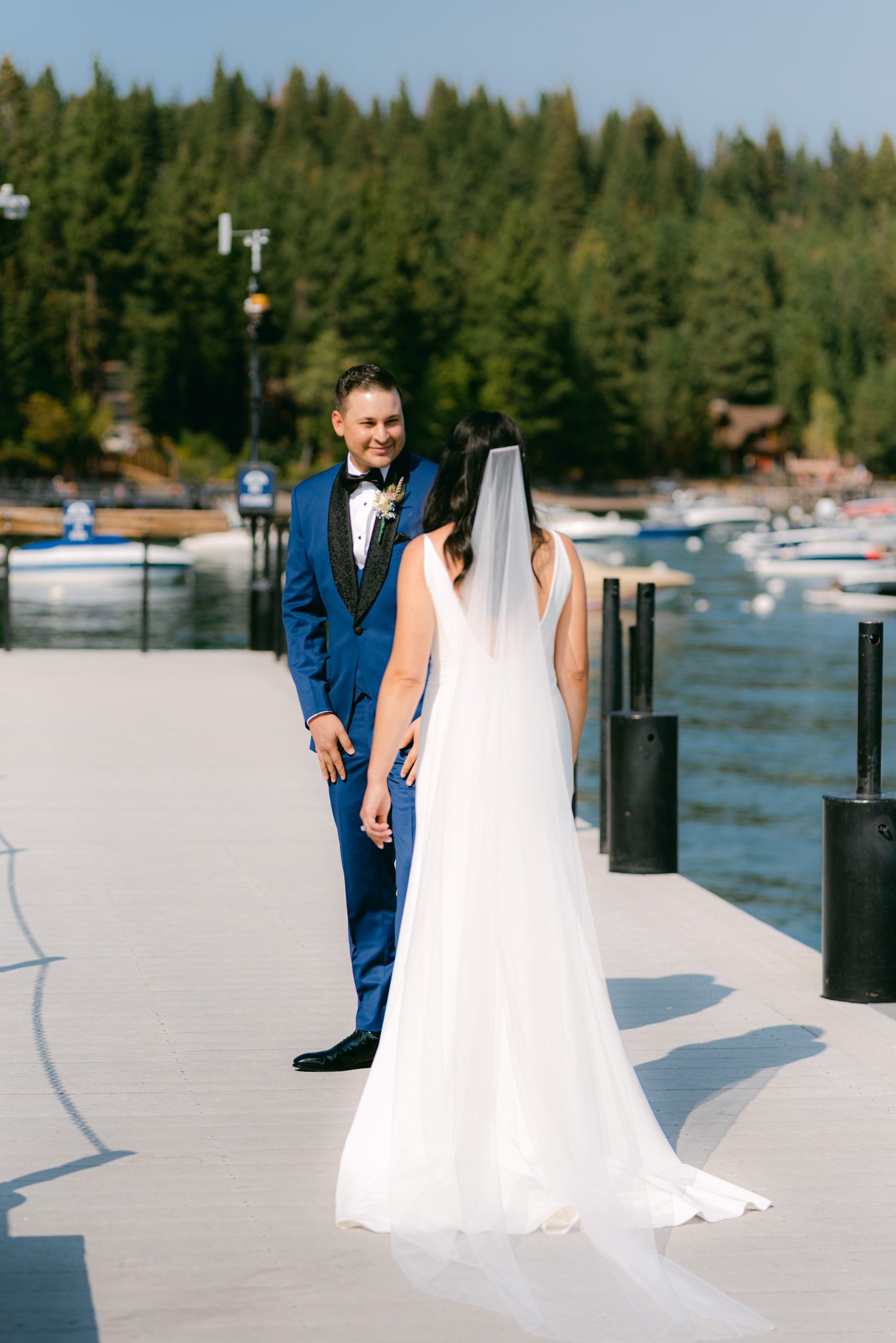 Sunnyside Tahoe Wedding, photo of couple having their first-look on a Tahoe Dock