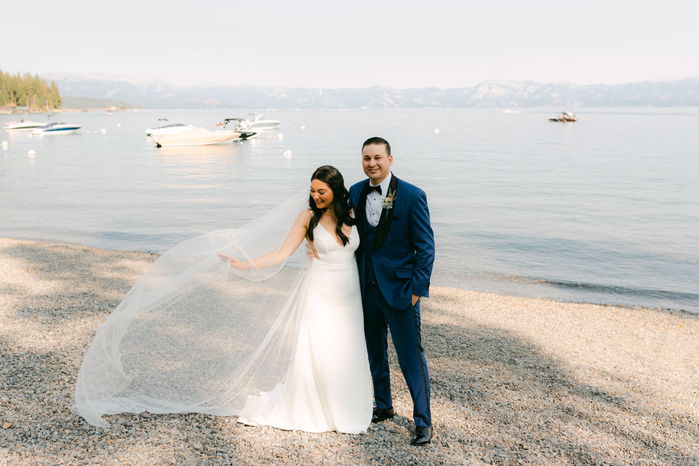 Sunnyside Tahoe Wedding, photo of a couple and bride playing with her cathedral veil