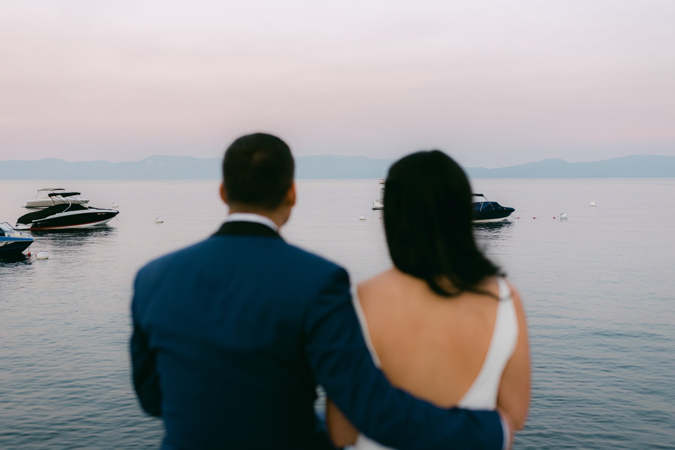Sunnyside Tahoe Wedding, photo of couple watching sunset from sunnyside dock