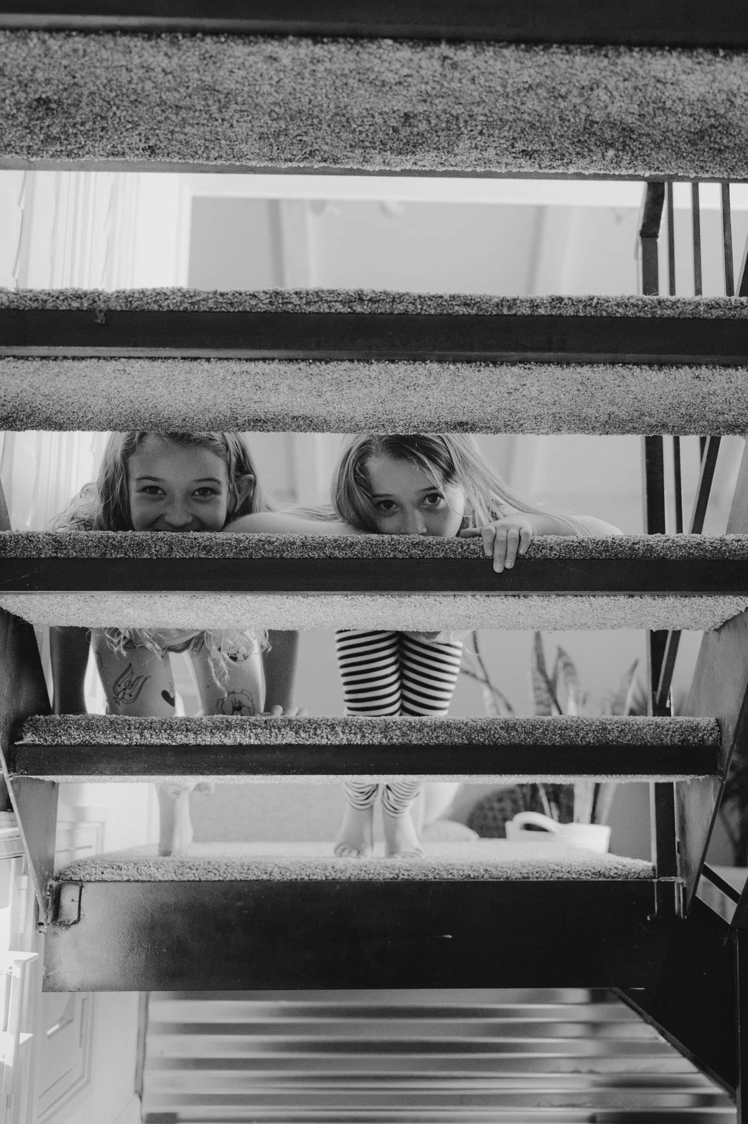 Move-in family photoshoot, photo of girls hanging out on the staircase  
