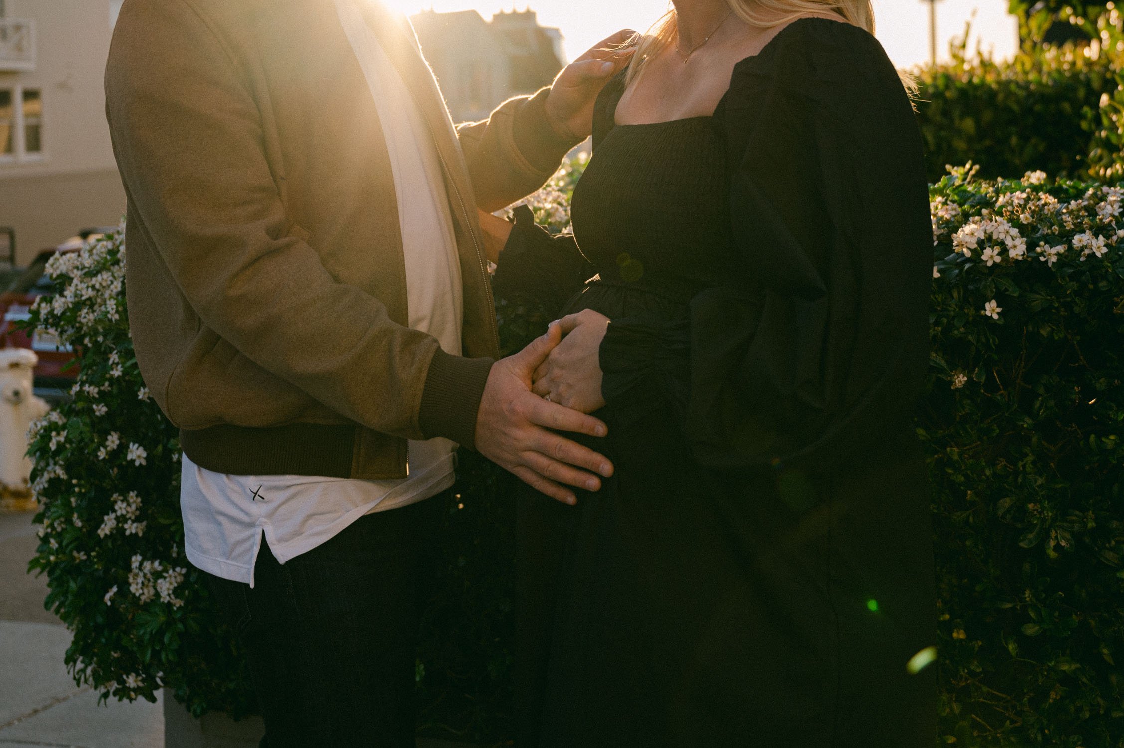 san francisco maternity session, photo of couple walking near a park, during golden hour