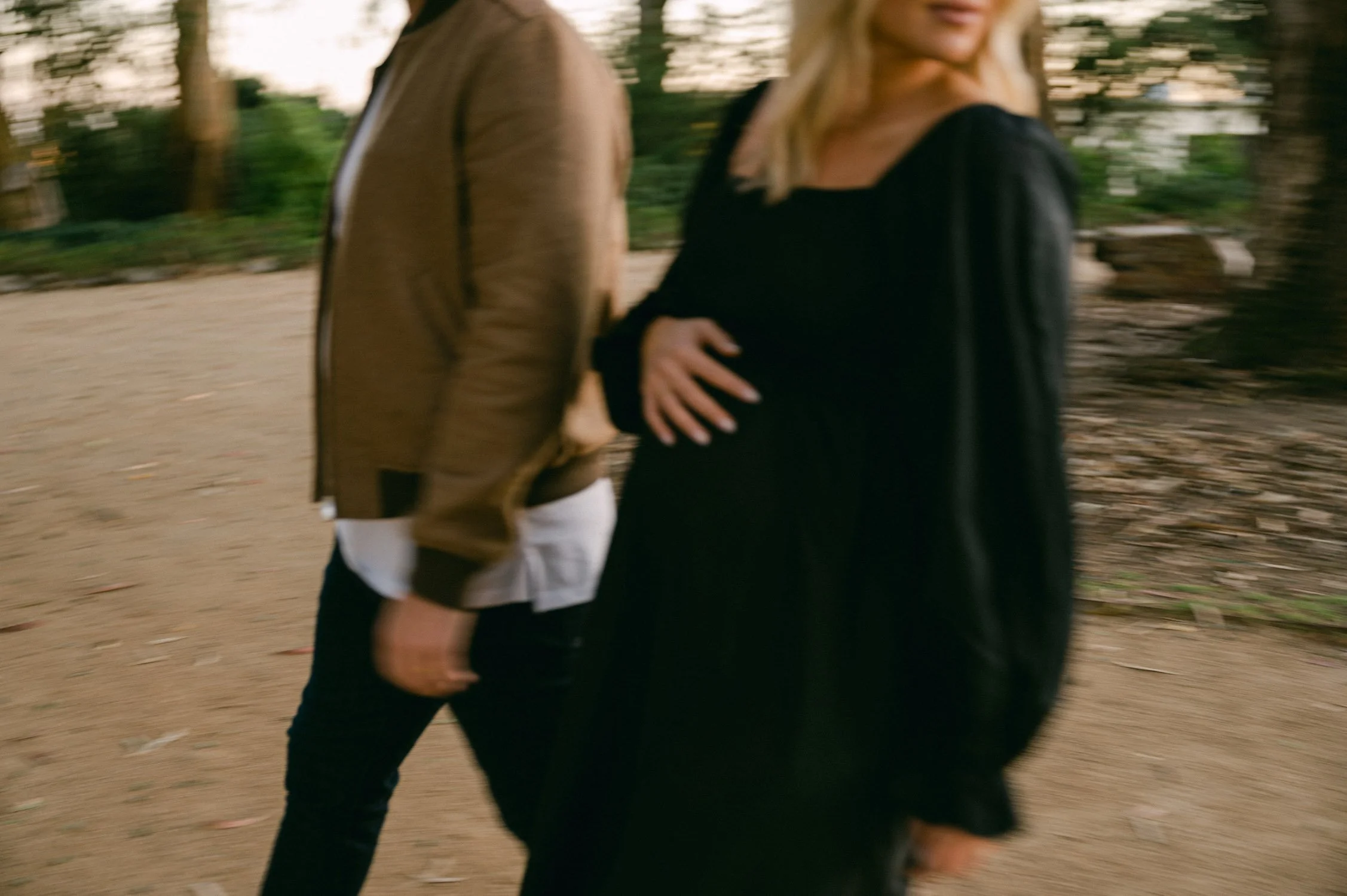  An urban san francisco maternity session, photo of mom waring a black modern maternity cotton dress with white tennis shoes