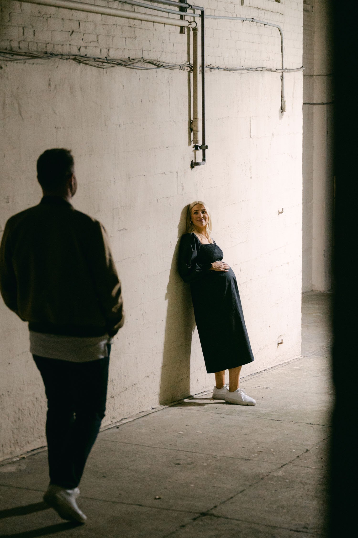  An urban san francisco maternity session, candid photo of couple in an alley 