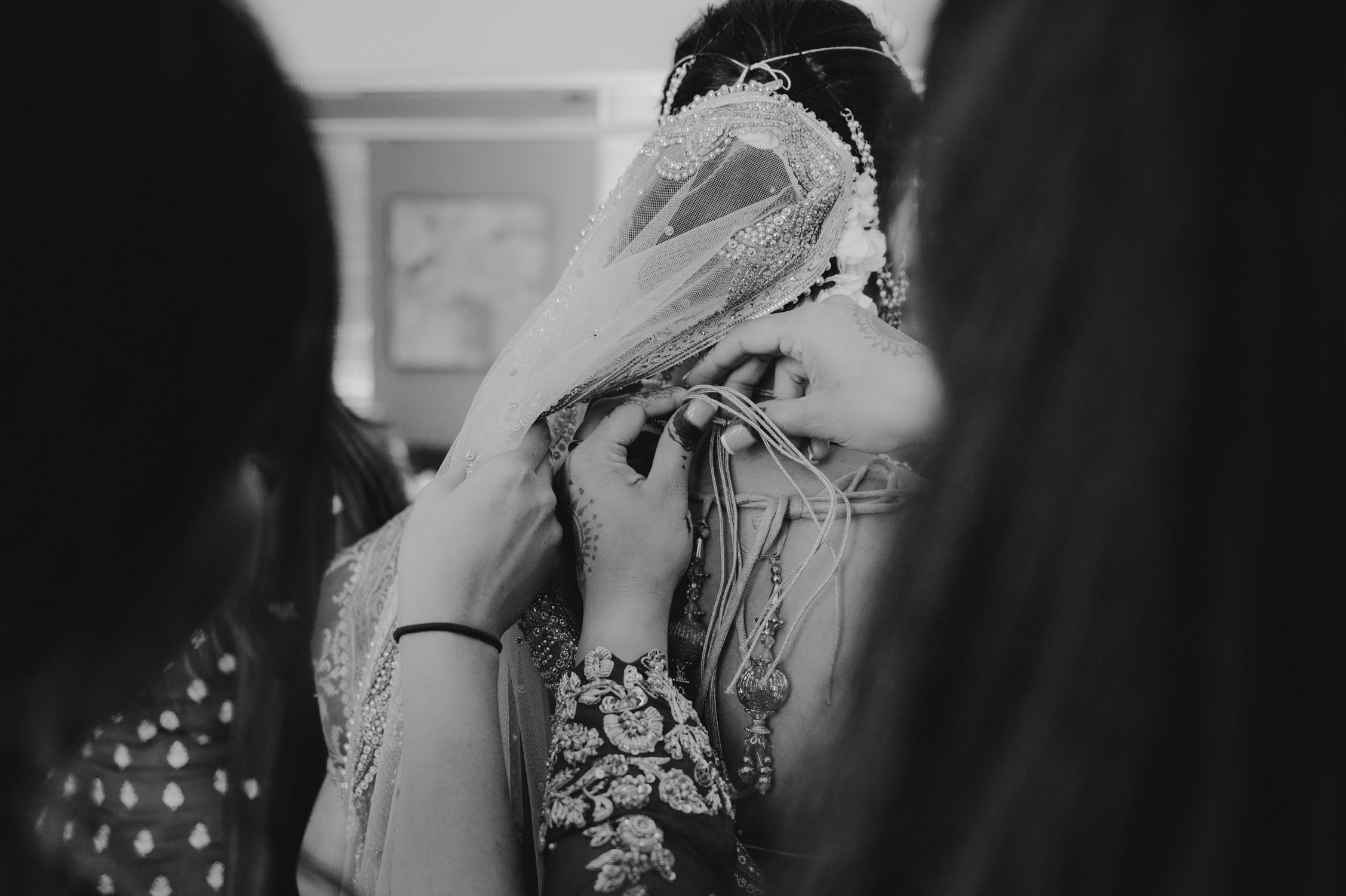 hindu ceremony, photo of bride getting help with the sarees