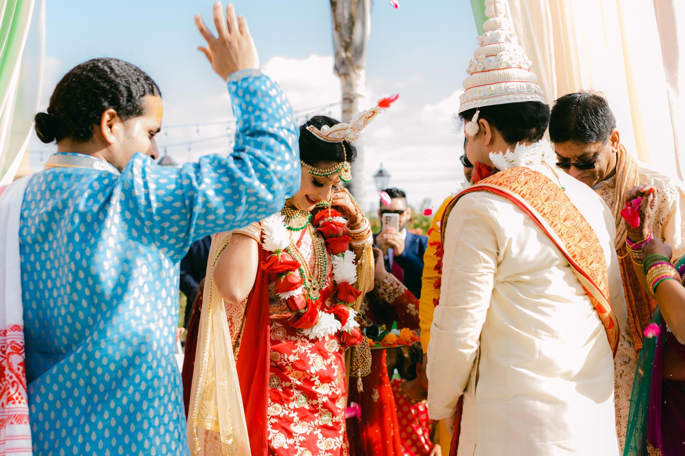 Hindu ceremony, photo of bride getting a flower neckless  