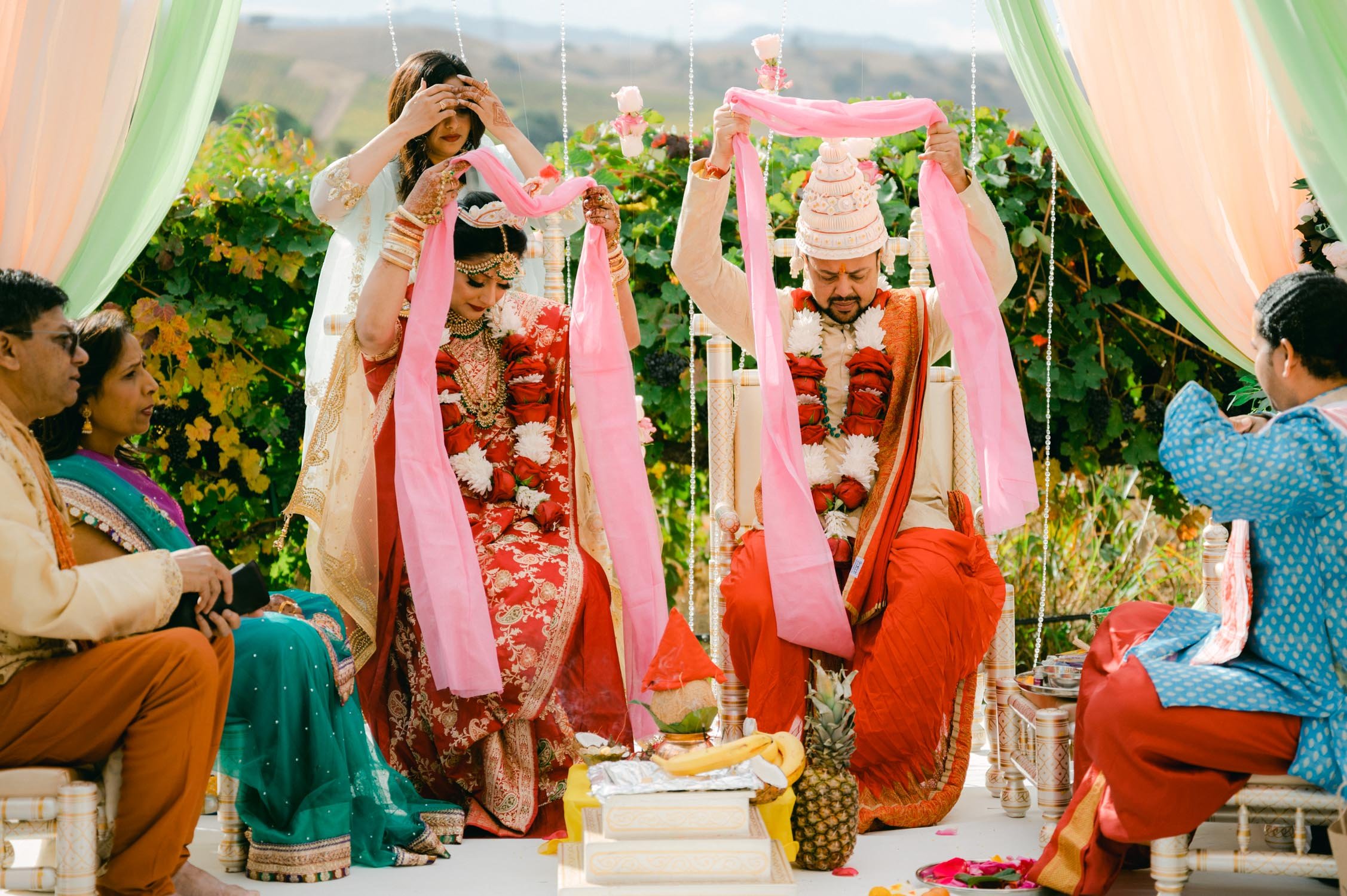 Hindu ceremony, photo of couple wearing a pink scarf 