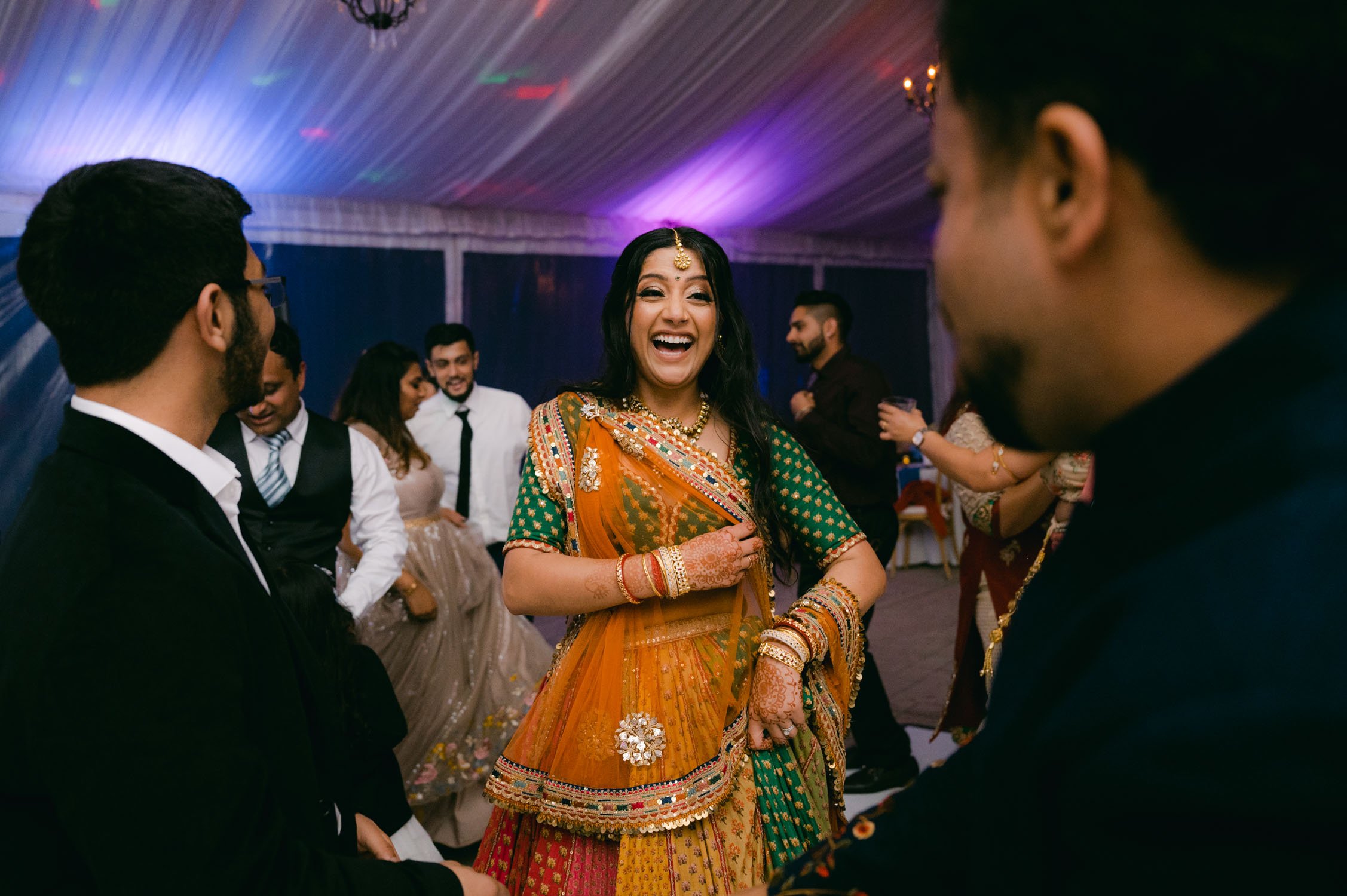Indian wedding reception, photo of bride dancing 