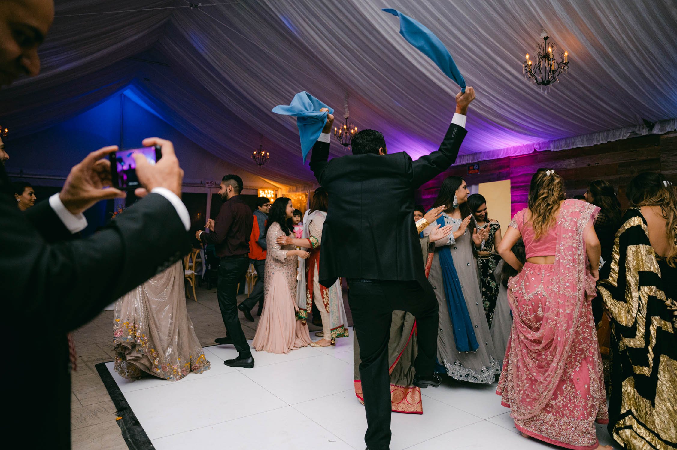 Indian wedding reception, photo of guest throwing linen napkins