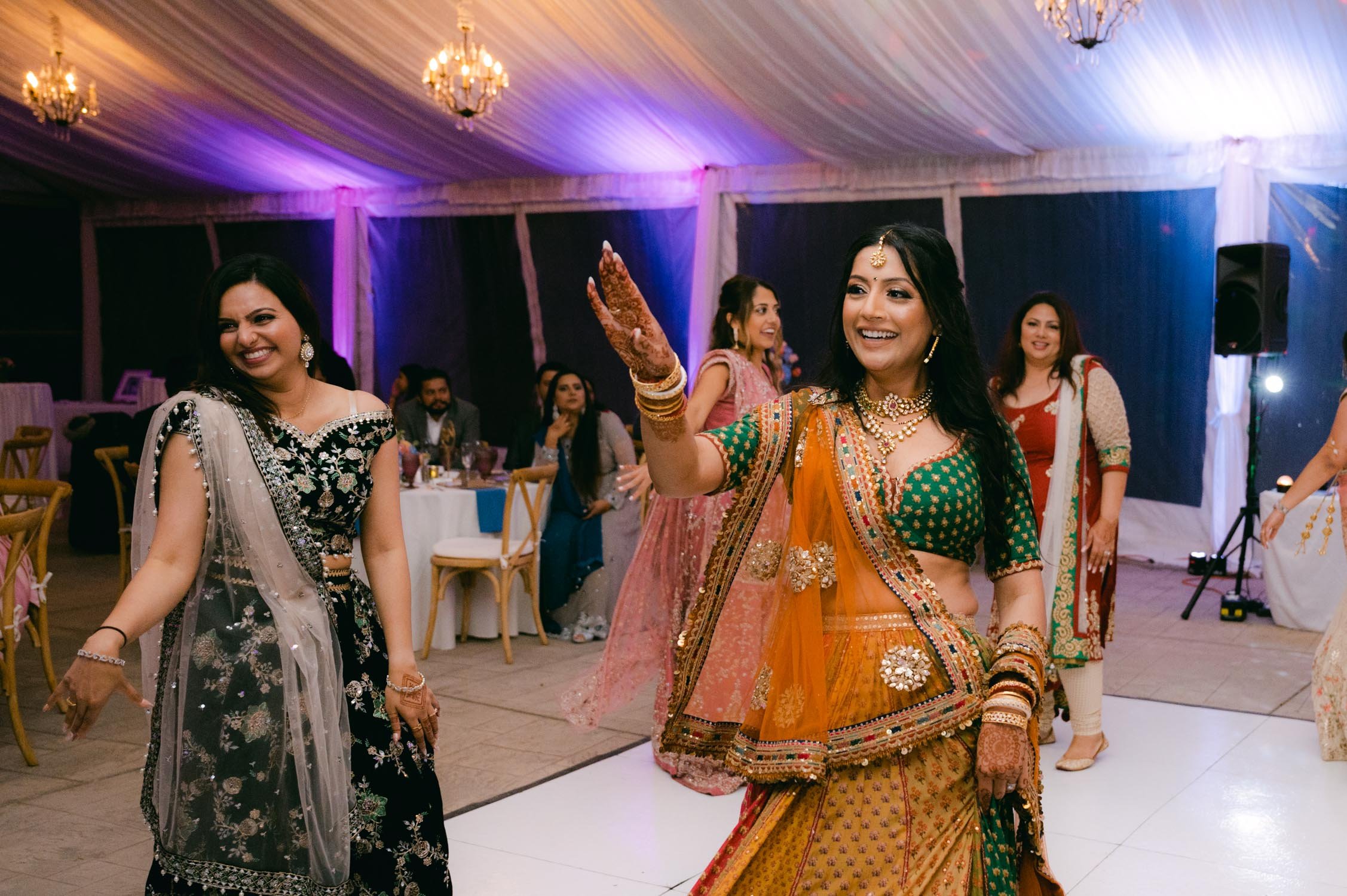Indian wedding reception, photo of bride and bridesmaids dancing